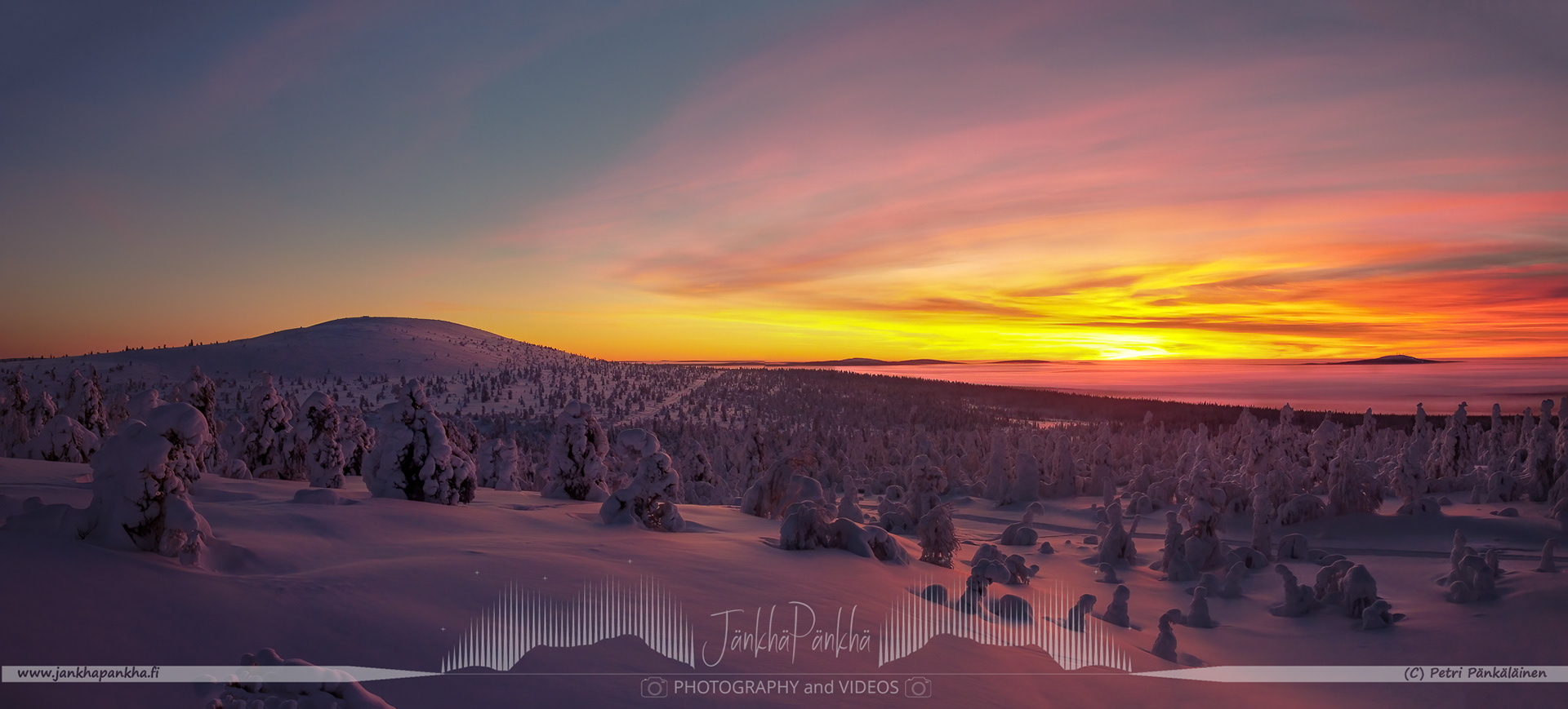 Vibrant orange and yellow hues painting the sky during a polar night in Lapland's Pallas-Yllästunturi National Park. Silhuette of the Sammaltunturi in the horizon.