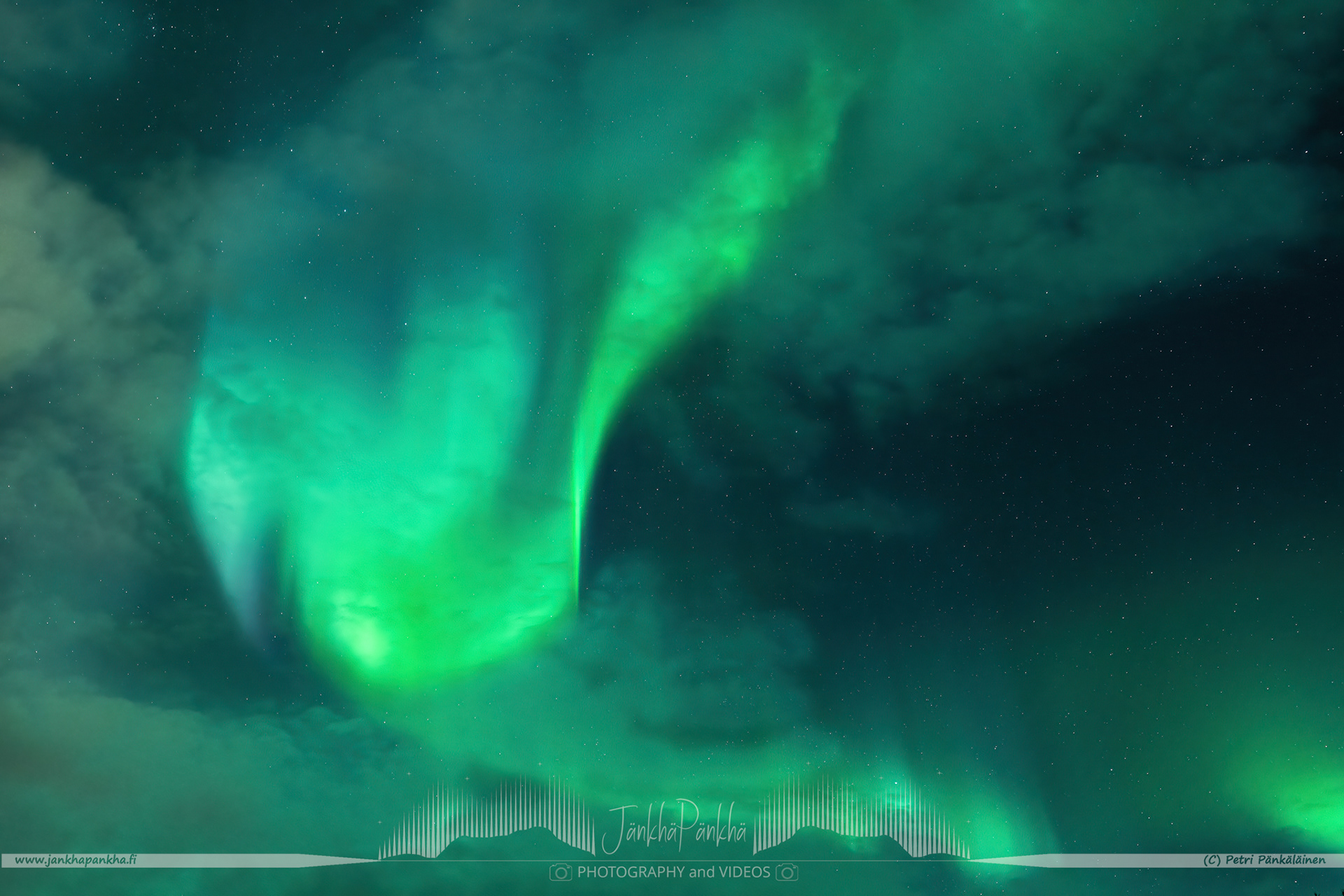 Rarely visible blue northern lights behind the clouds in Äkäslompolo, Finland