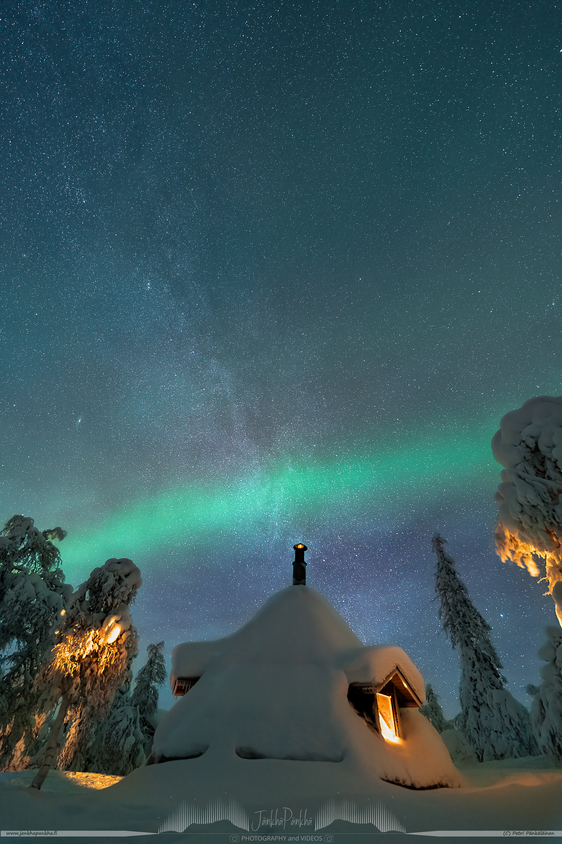 A cosy hut under the milkyway and northern lights. Surrounded by the candle spruces.