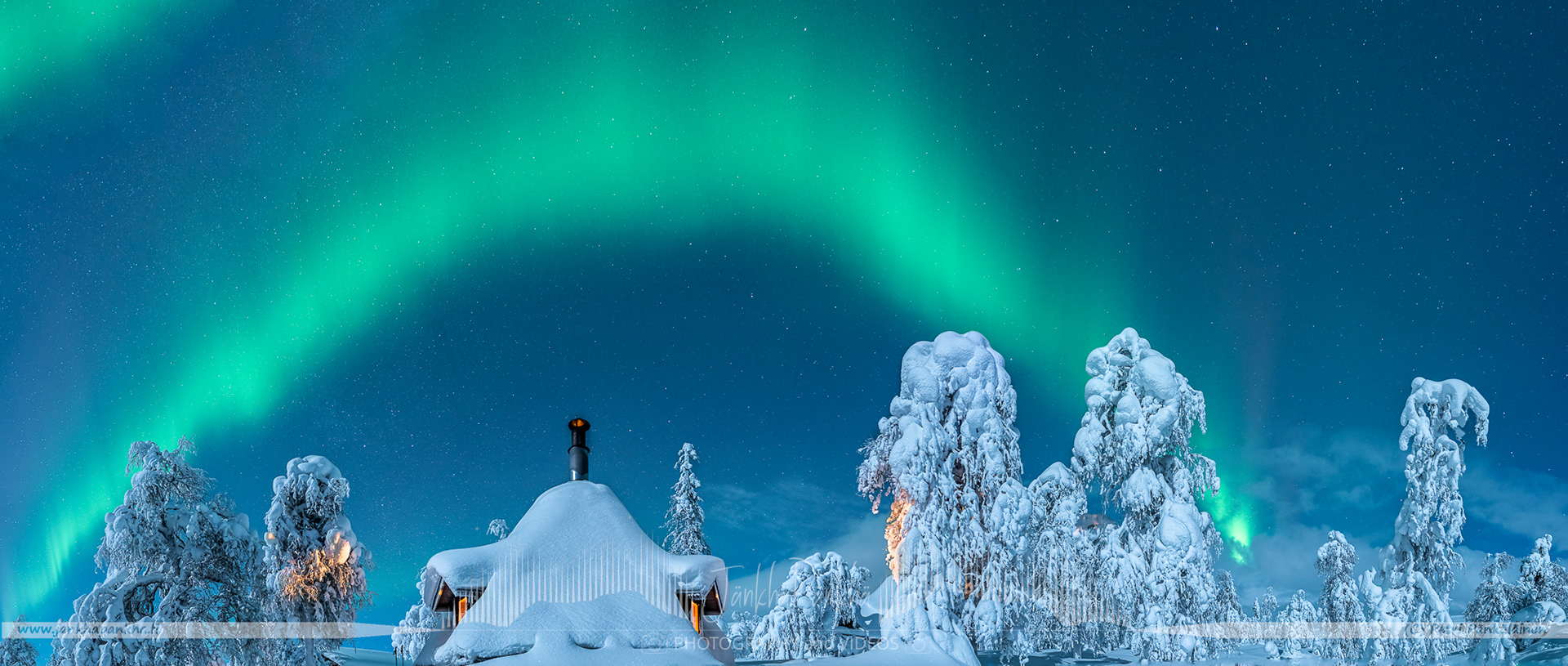 Northern lights over the snowy fell and forest in Lapland., Finland. 