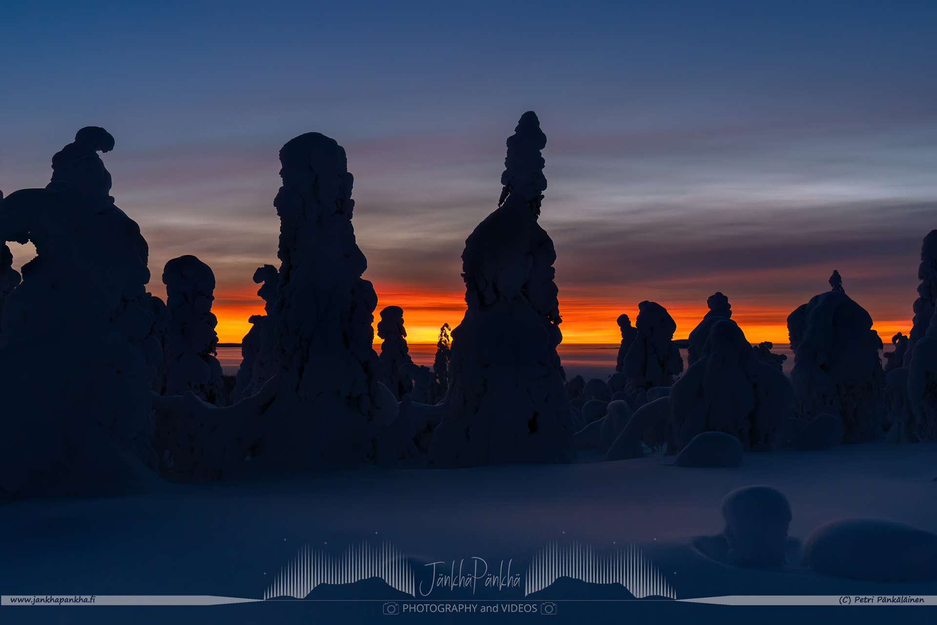 Intense colors of the polar night sunset and the valley covered with clouds in Muonio, Finland