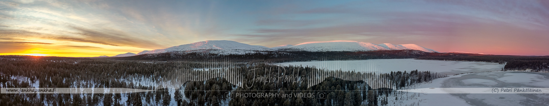 Pallas-Yllästunturi National Park's snowy landscapes bathed in the warm colors of a winter sunset.