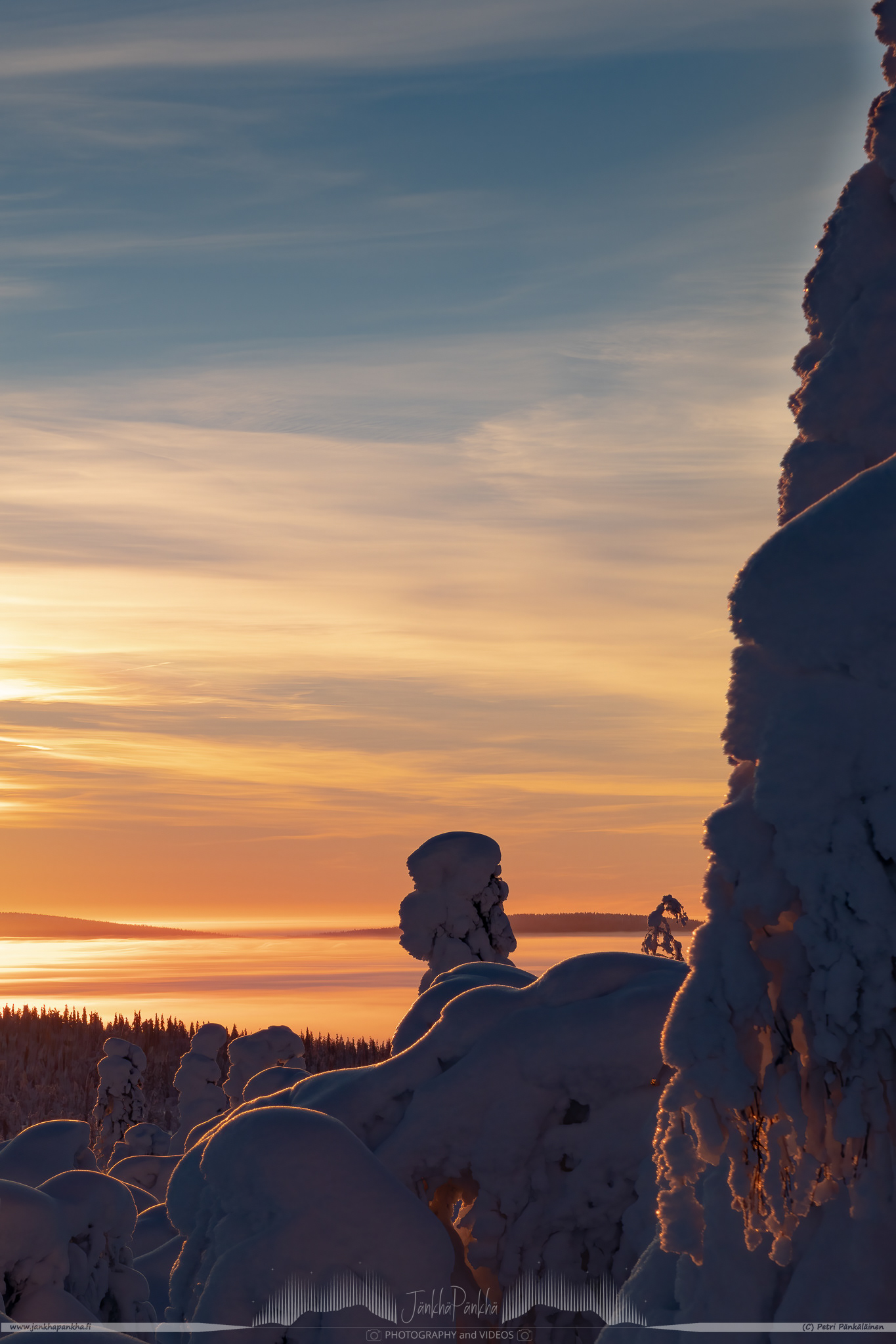 The valley covered with the low hanging clouds nearby the Pallastunturi fell. The Olostunturi fell and Muonio city in the horizon.