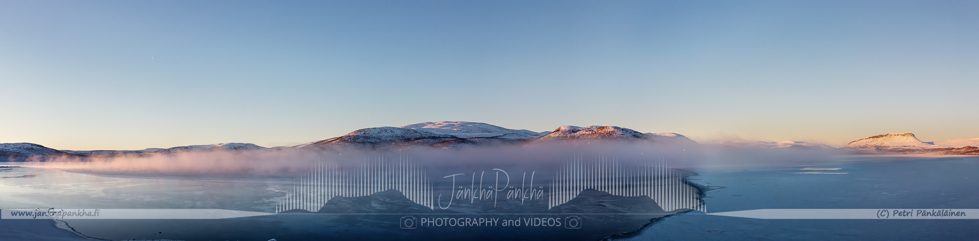 Beautiful pastel sunrise at Lake Kilpisjärvi, Enontekiö, with delicate colors mirrored on the frozen surface of the lake.