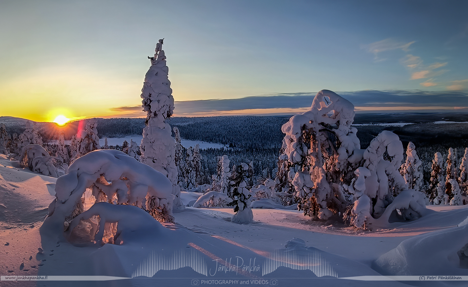Lapland's Pallas-Yllästunturi National Park featuring a serene sunset with orange and yellow tones.