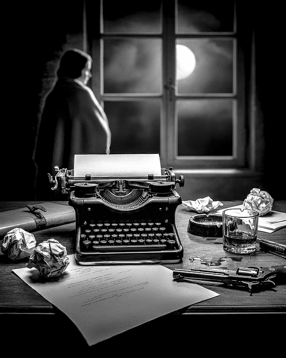 A vintage typewriter sits on a cluttered desk, with crumpled papers and a glass nearby. And a gun, a revolver. Moonlight streams through a window as a woman wrapped in a blanket, stands silhouetted, gazing outside at the moon. Black and white by Bob Orsillo