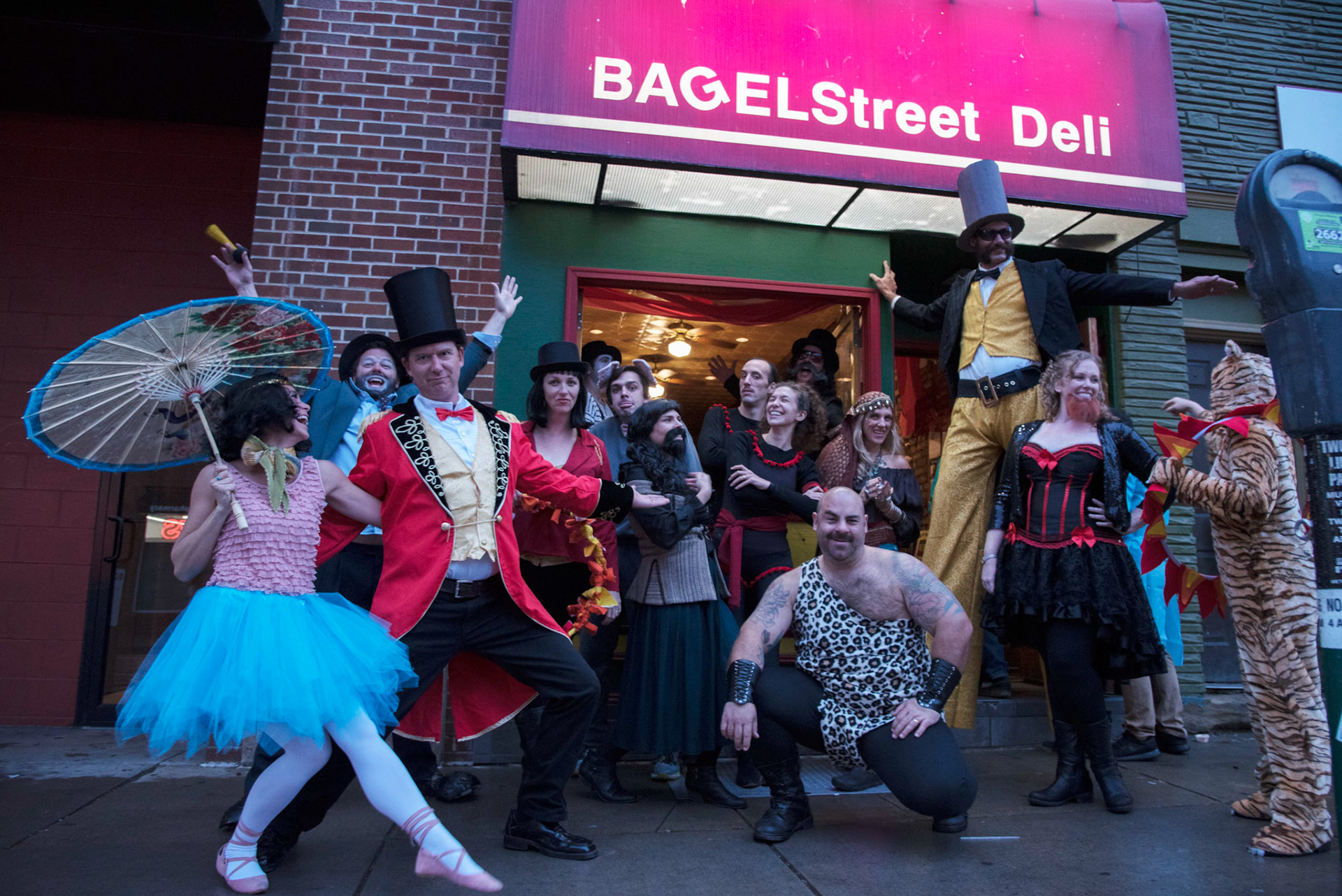 Bagel Street Deli owner, Lenny Meyer, and a group of friends and coworkers pose in front of the restaurant on Saturday, October 27 on Court Street in Athens, Ohio. The group of friends dressed up members of a circus and enjoyed a private party in the restaurant, a ritual they do Halloween.