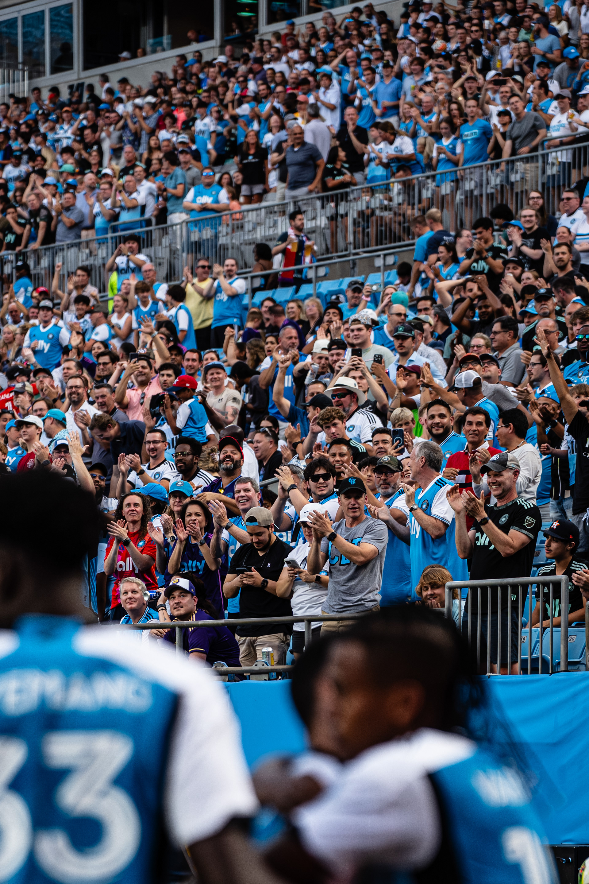 Charlotte FC supporters celebrate Kerwin Vargas’ goal in the background, MLS, USA. © AndyMaxPhotography. All rights reserved.
