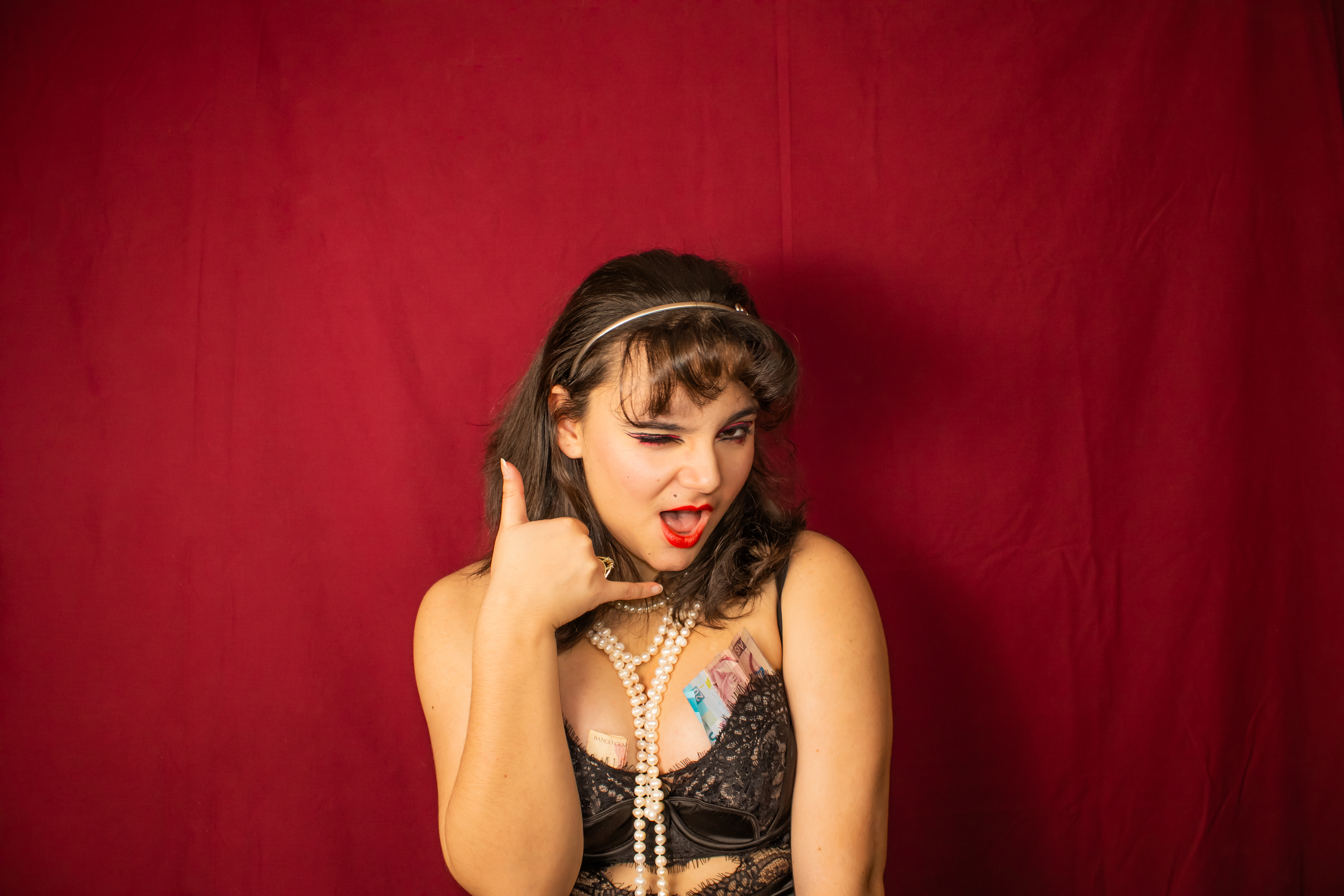 Call Girl, 2023. In this piece, the artist becomes the architype of an exotic dancer. Through colour, wardrobe and acting, the artist illustrates one of the four architypes of women represented in this series.