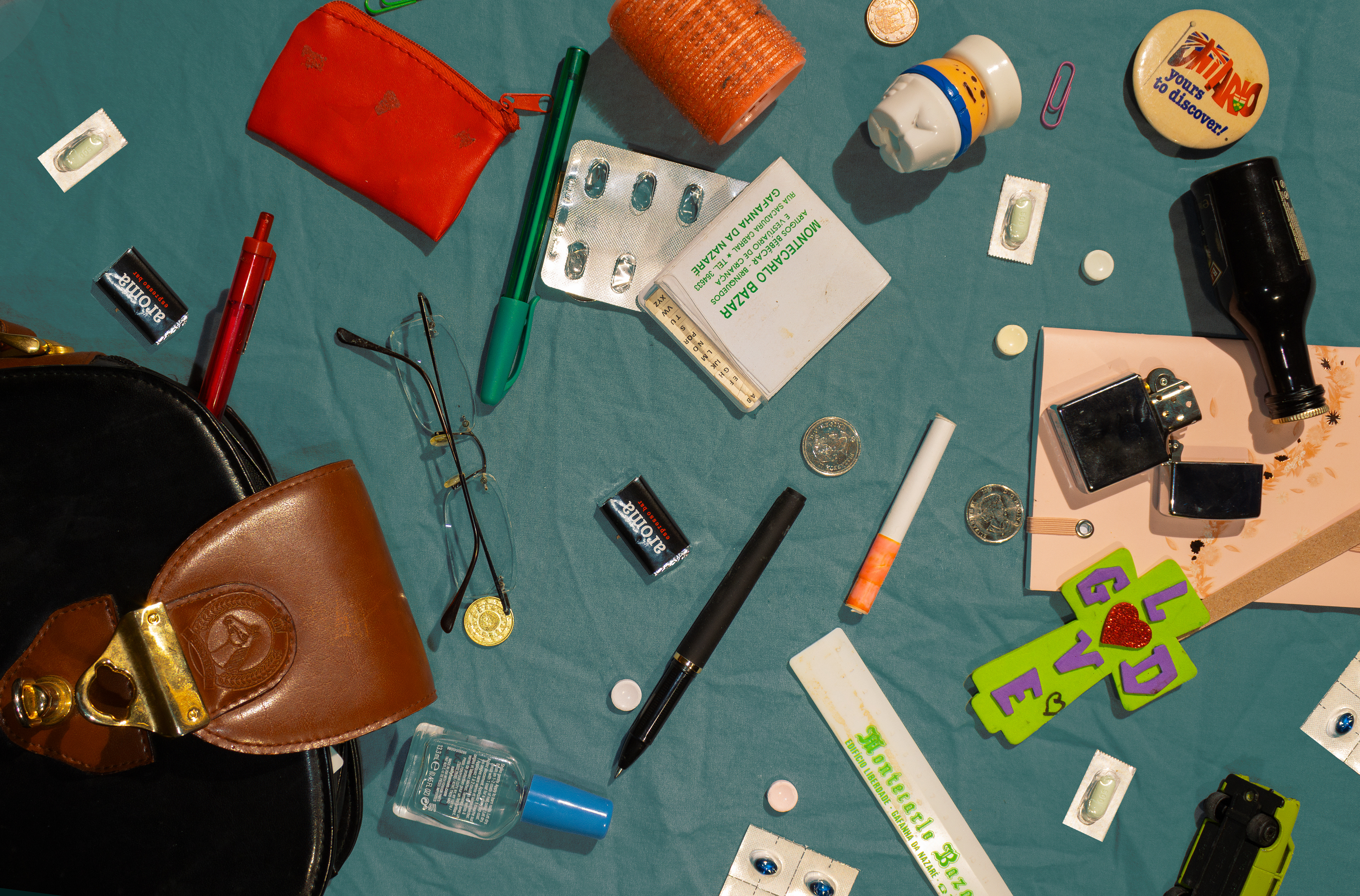  Mean Teach Bag, 2023. Cigs, a mini, scattered, varying pills and confiscated toys are the making of a God fearing, overly disciplining teacher, no?