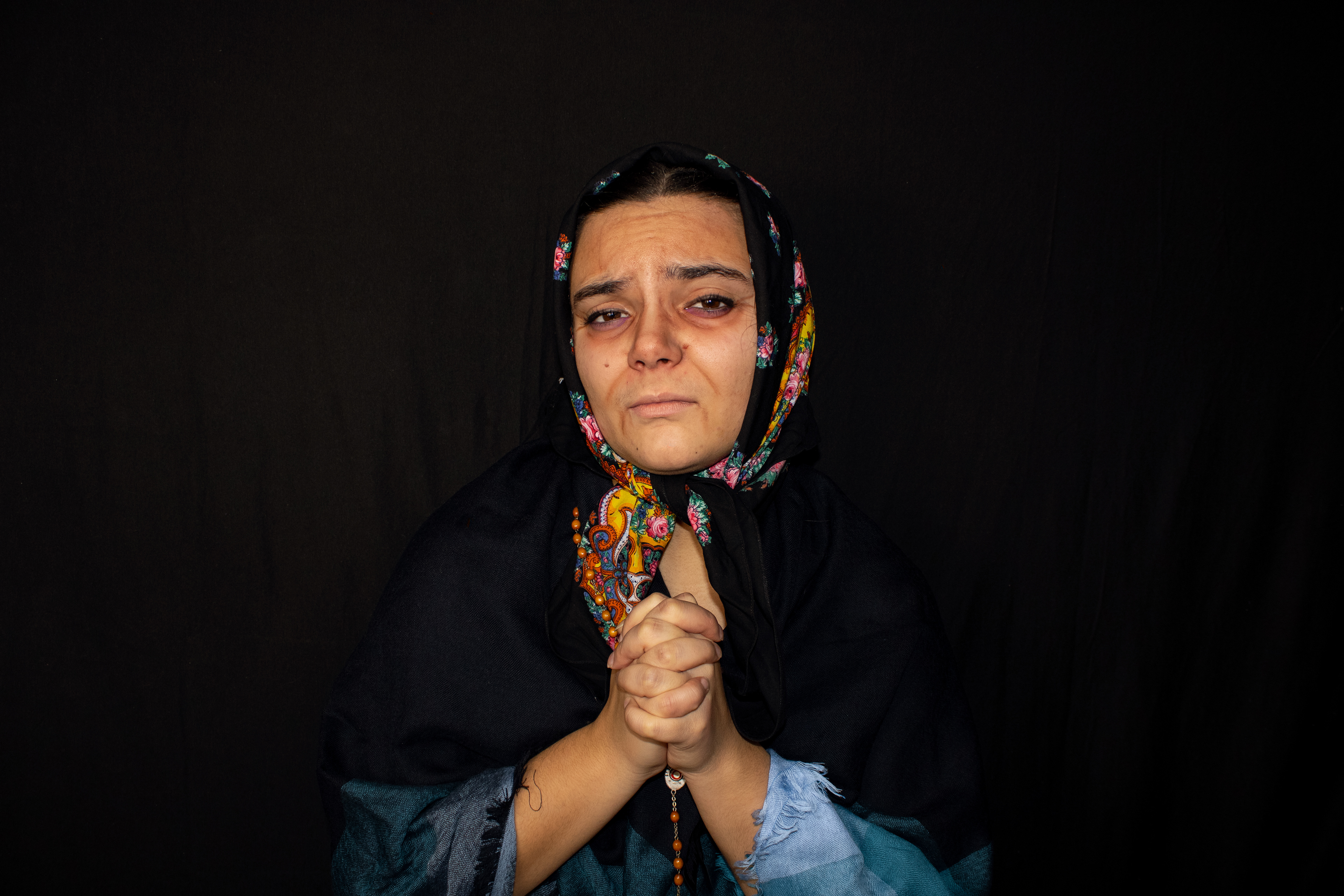 Incomplete, 2023. Inspired by the older Portuguese women the artist grew up with, the artist reflects on the architype of the old, mourning woman. Having lost her husband many years ago, this woman refuses to ever wear full colour again - only allowing pops in her headscarf, rosary, and shall. 