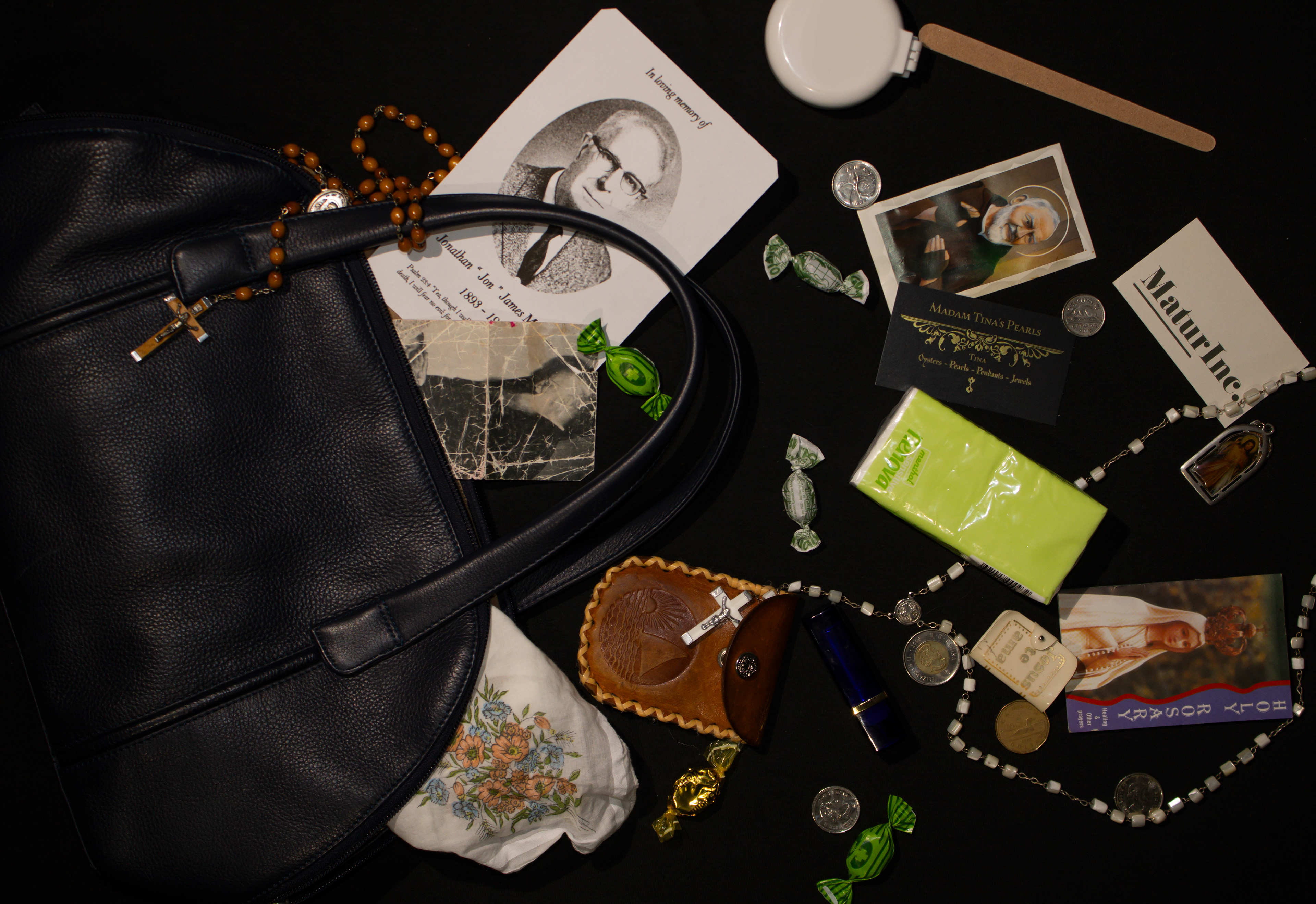Incomplete Bag, 2023. This woman has completely lost her own sense of identity - she is now merely an object of mourning. Someone who never leaves without her husband’s obituary, tissues, prayer cards and throat lozenges.