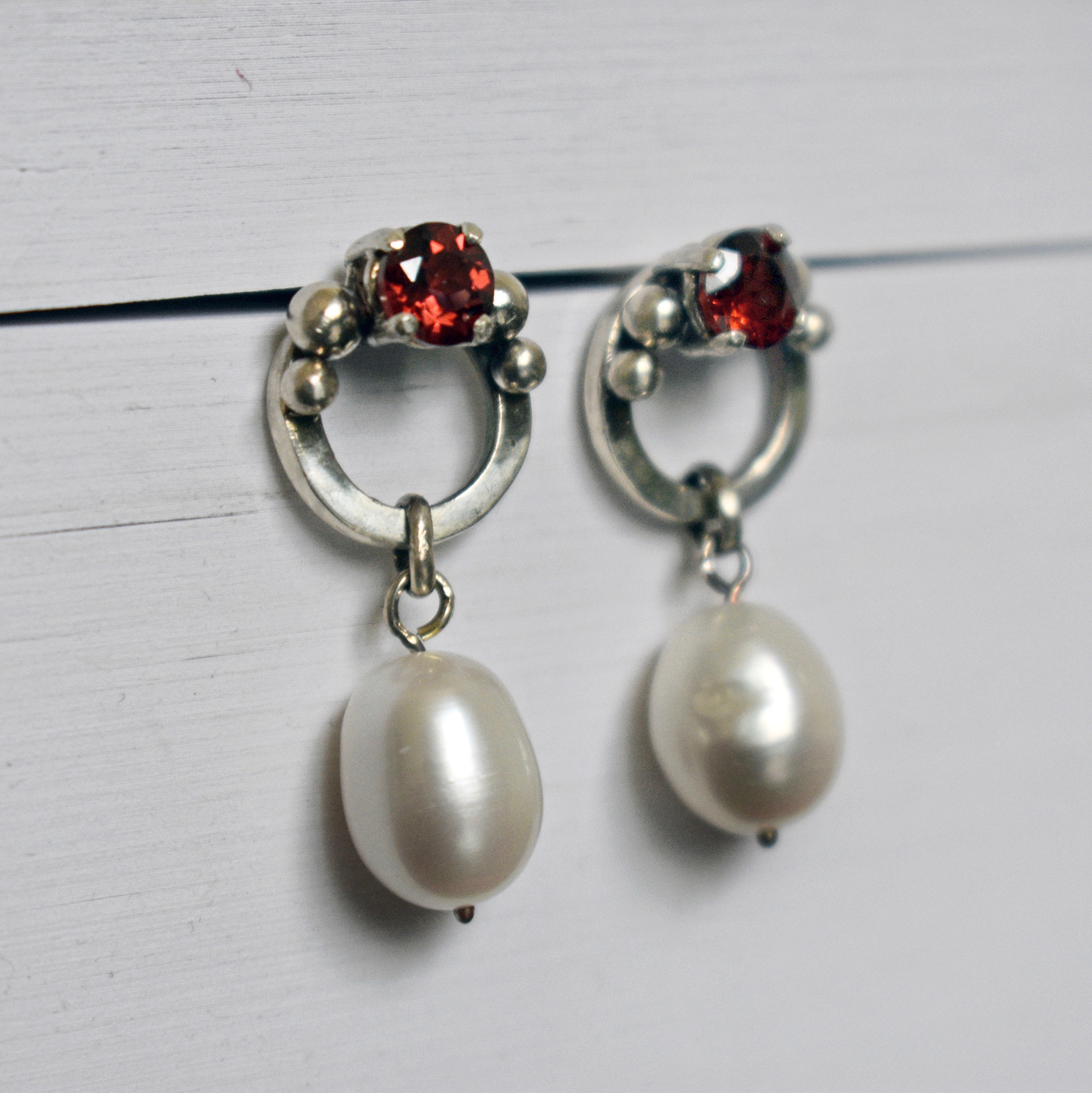 prong-set garnet earrings with pearl drops