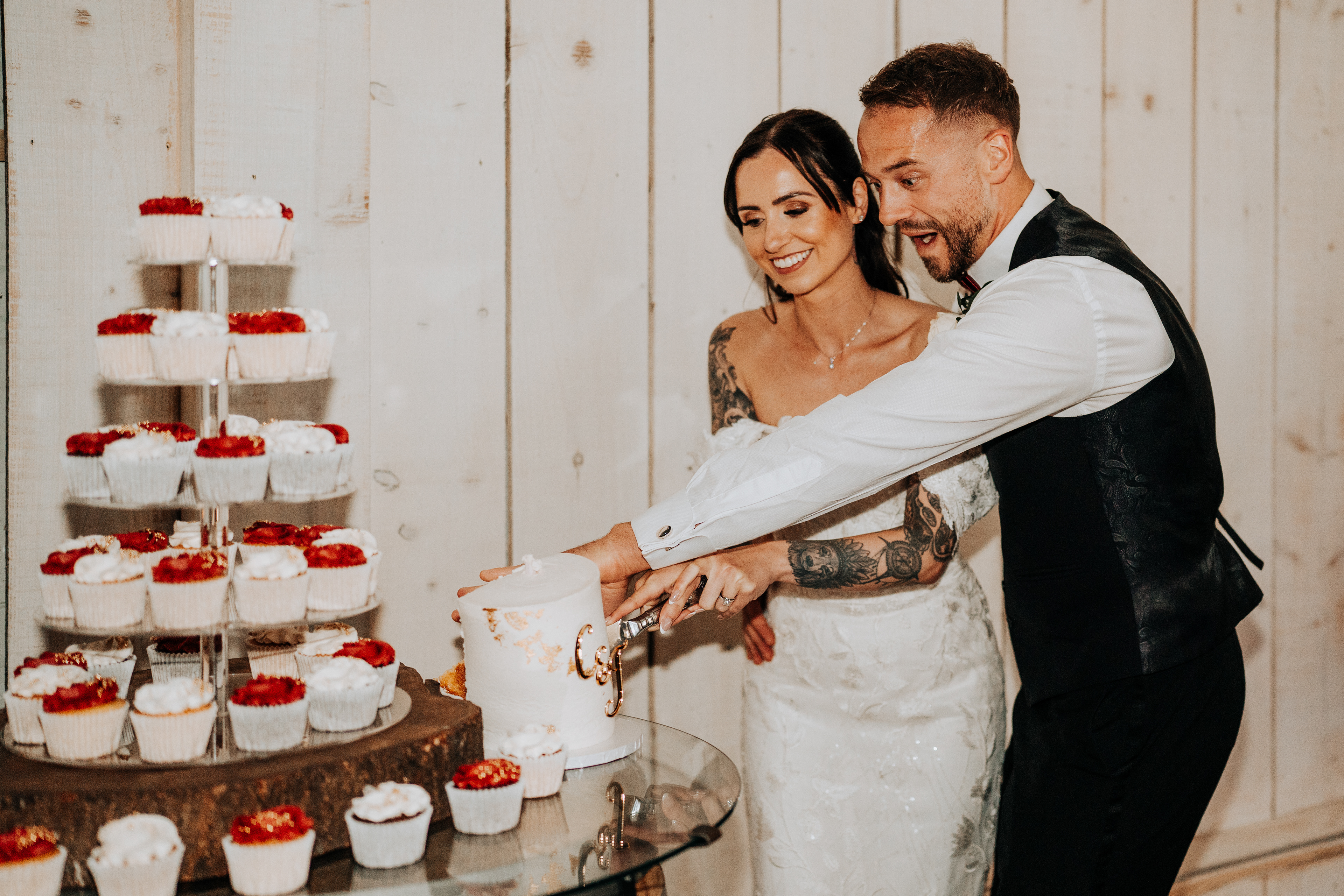 Realistic wedding photography and videography at Ashton Lodge cake cutting goes wrong