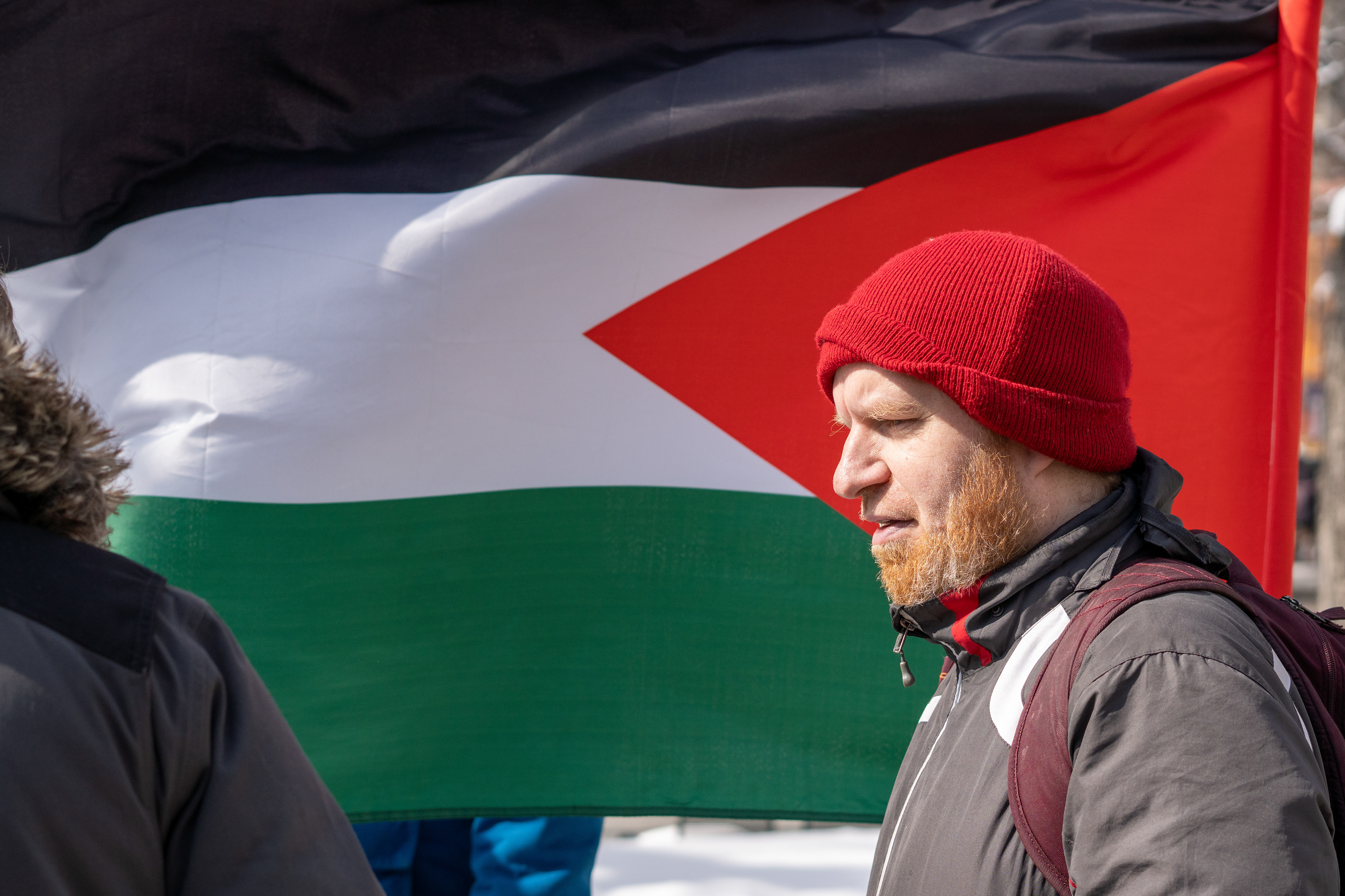 A demonstrator stands solemnly at the Freedom for Palestine Rally at Calgary City hall on Sunday, March 24, 2024.