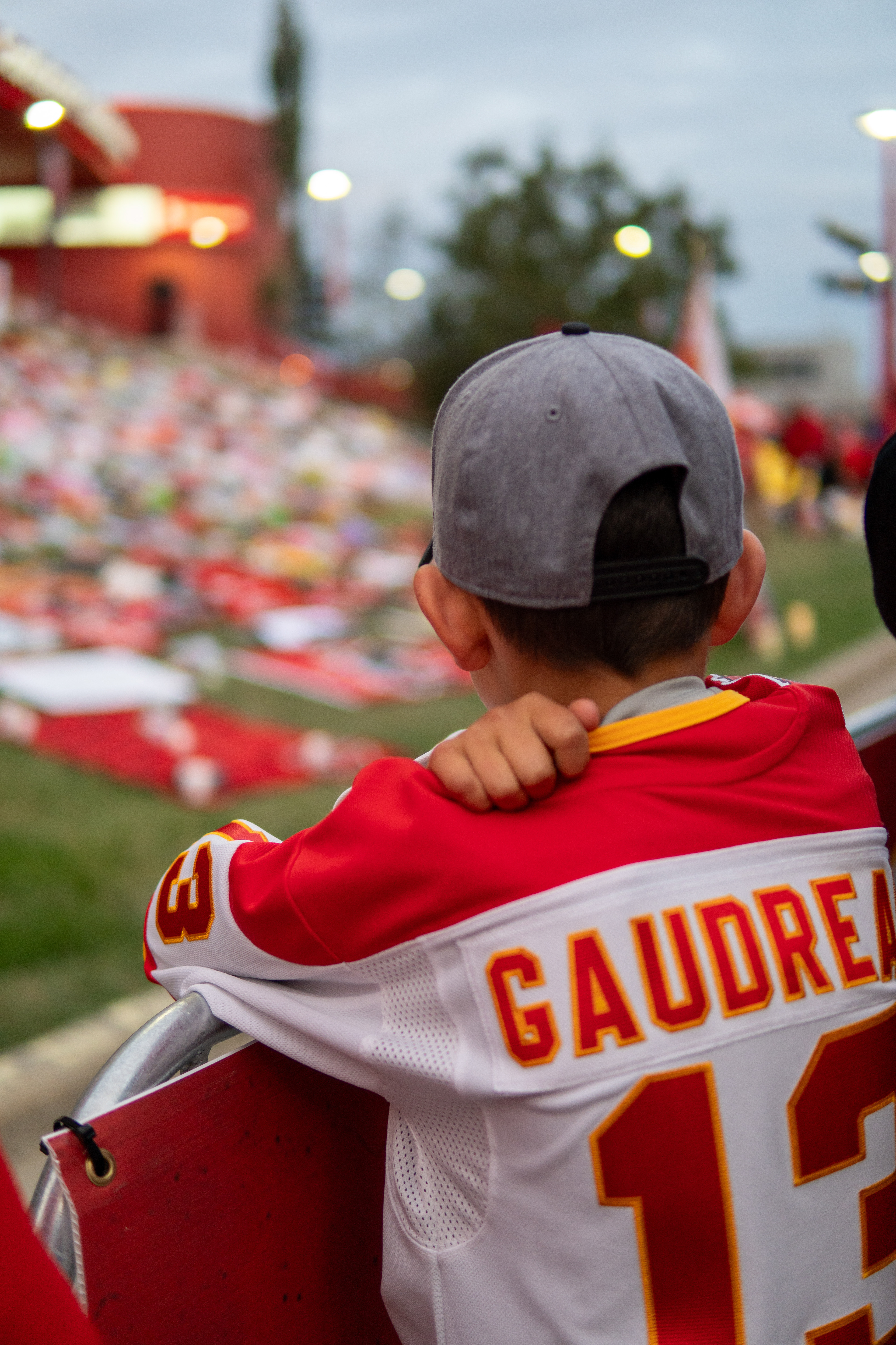 A young fan looks onto the memorial made by fans for Johnny Gaudreau in front of the Saddledome in Calgary on Wednesday, Sept. 4, 2024.