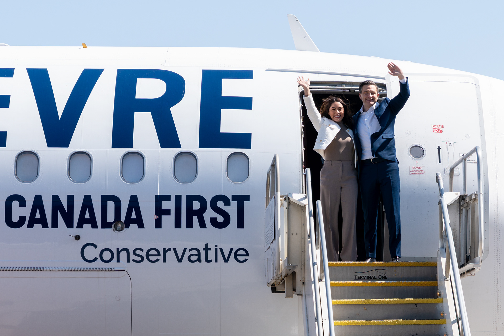 Conservative leader Pierre Poilievre waves to the crowd off of his plane at a campaign stop in Calgary on Friday, April 25, 2025. (Photo by Mathew Pitt/The Press)