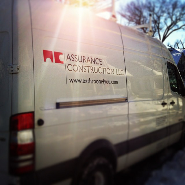 Assurance Construction logo on a van