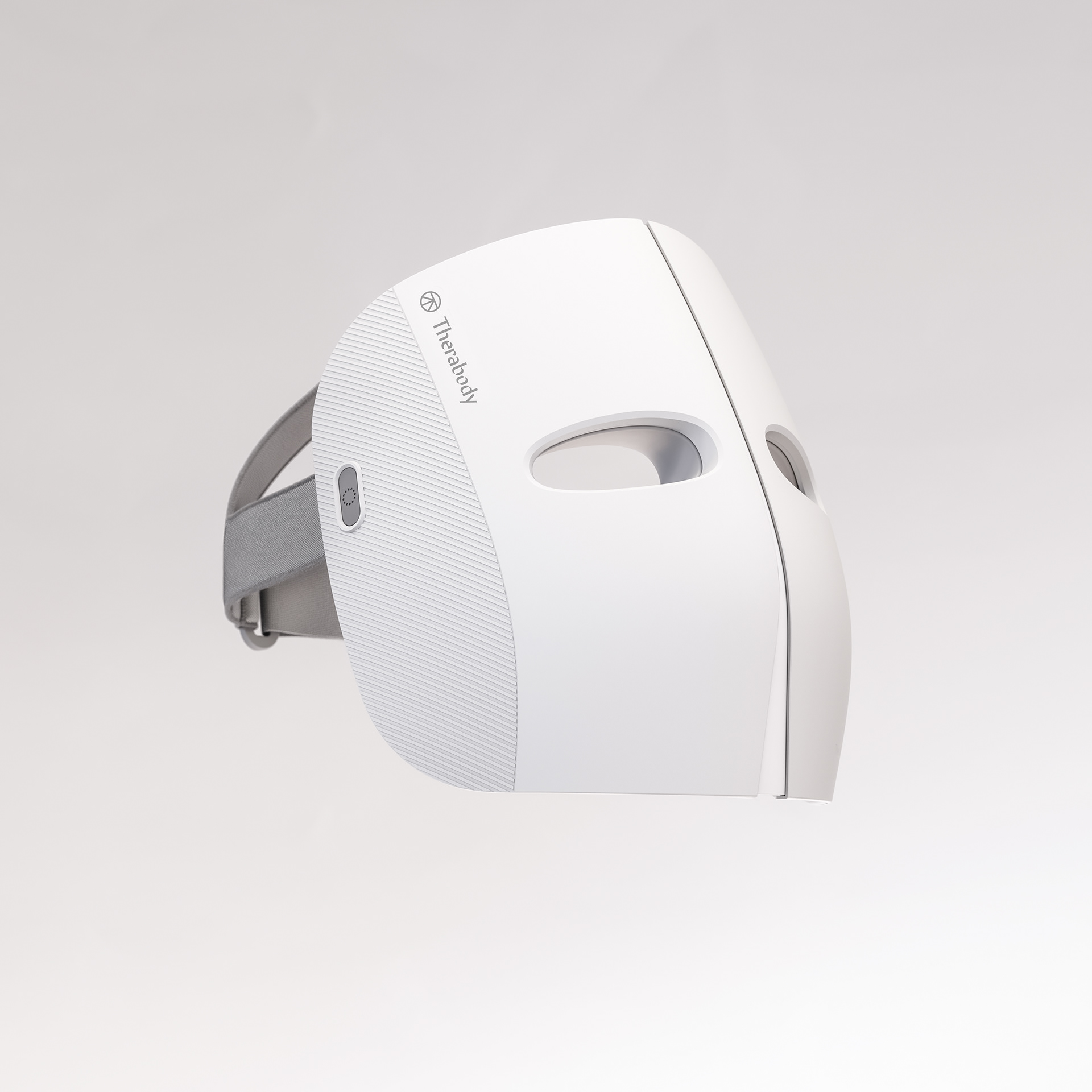 A white, sleek mask with a circular design, featuring a USB port on the side and a small button at the top.