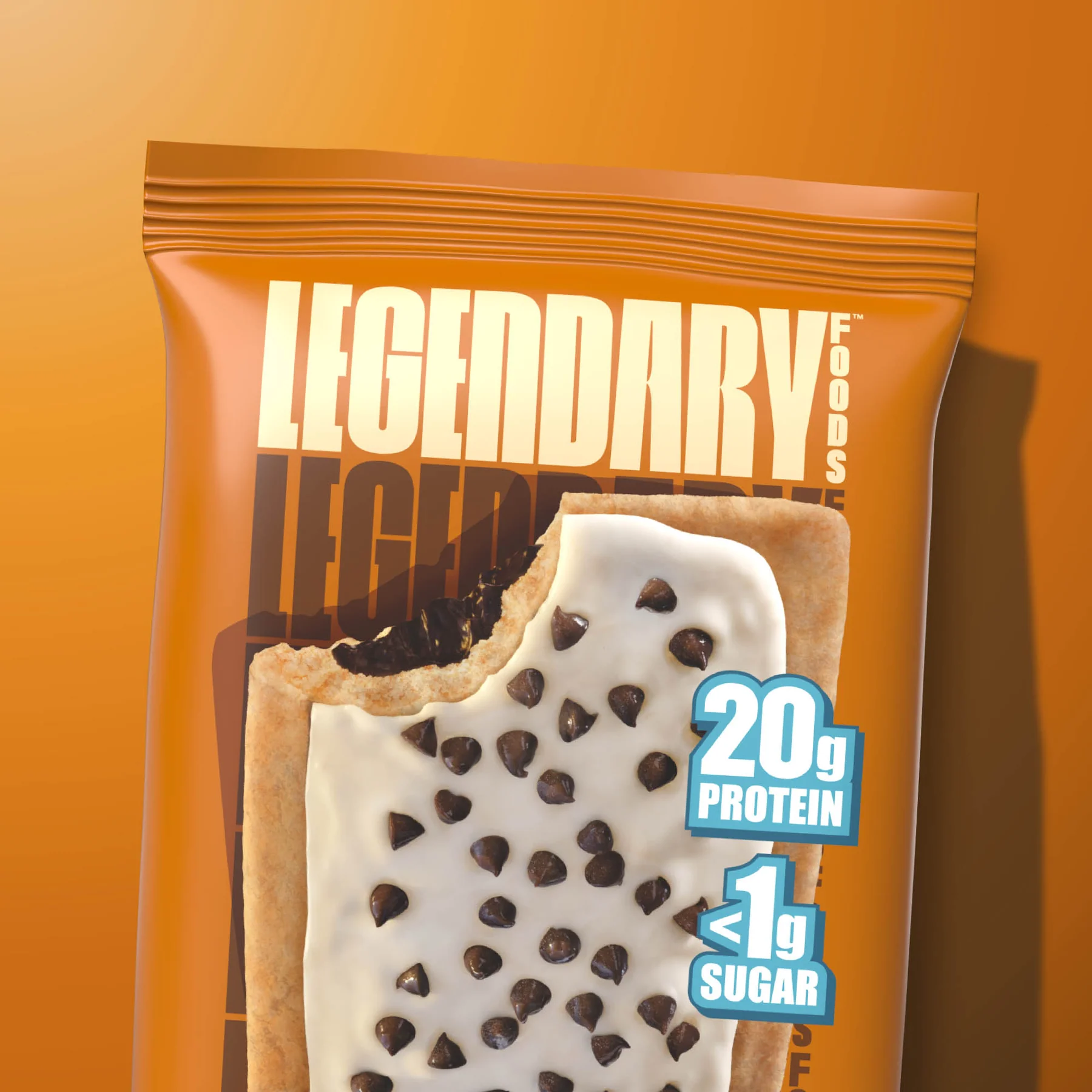 A package of "Legendary Foods" cookies with a bite taken out, showing chocolate chips and white cream filling, with "20g Protein" and "<1g Sugar" highlighted.