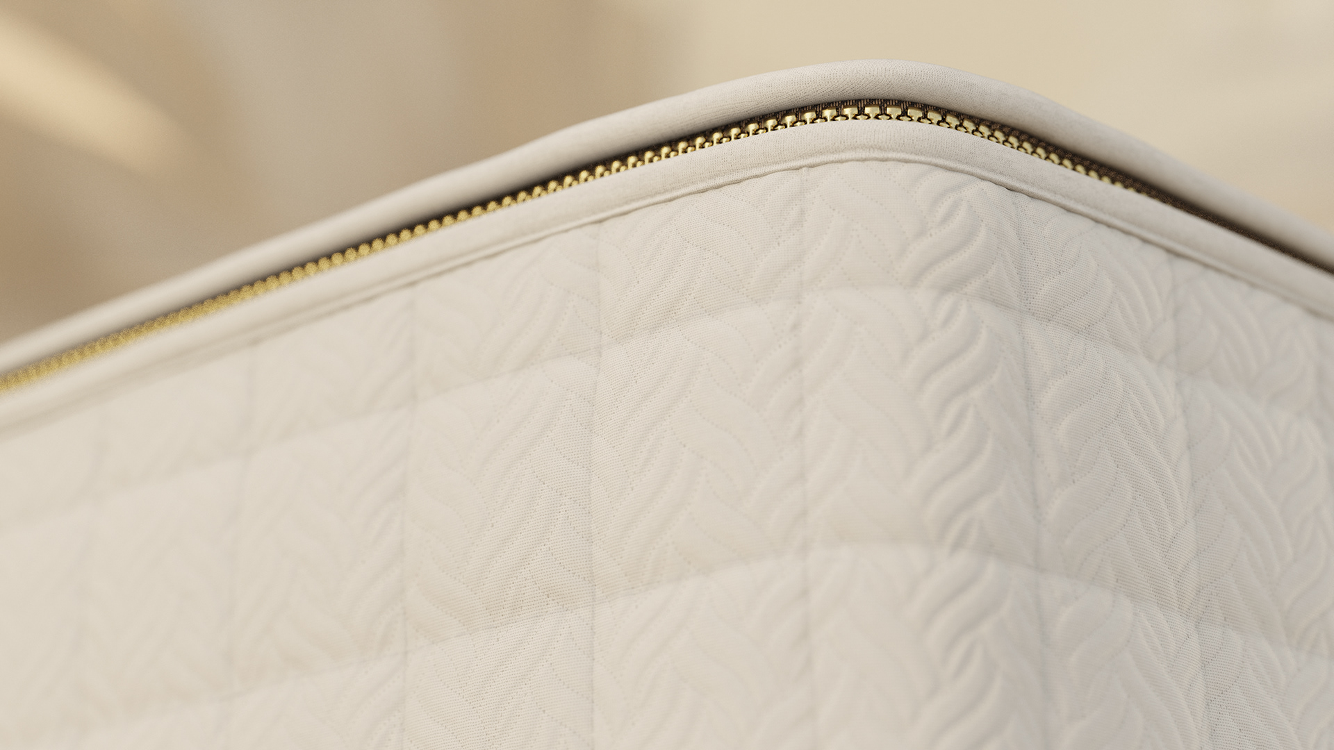 Close-up of a white mattress with a quilted pattern and gold zipper, showing texture and craftsmanship.