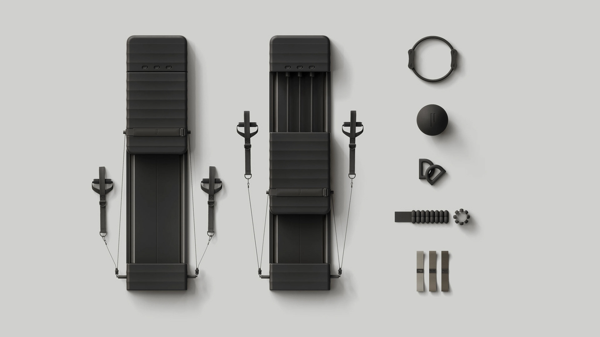 A black Pilates equipment set includes two black straps, a black handle, a black ball, and various metal components.