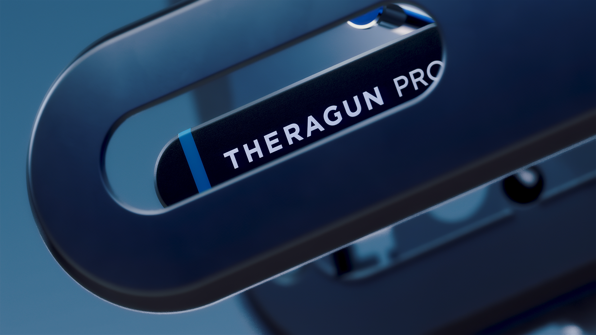 A close-up of a Theragun Pro device, showing its sleek black and blue design with the brand name prominently displayed.
