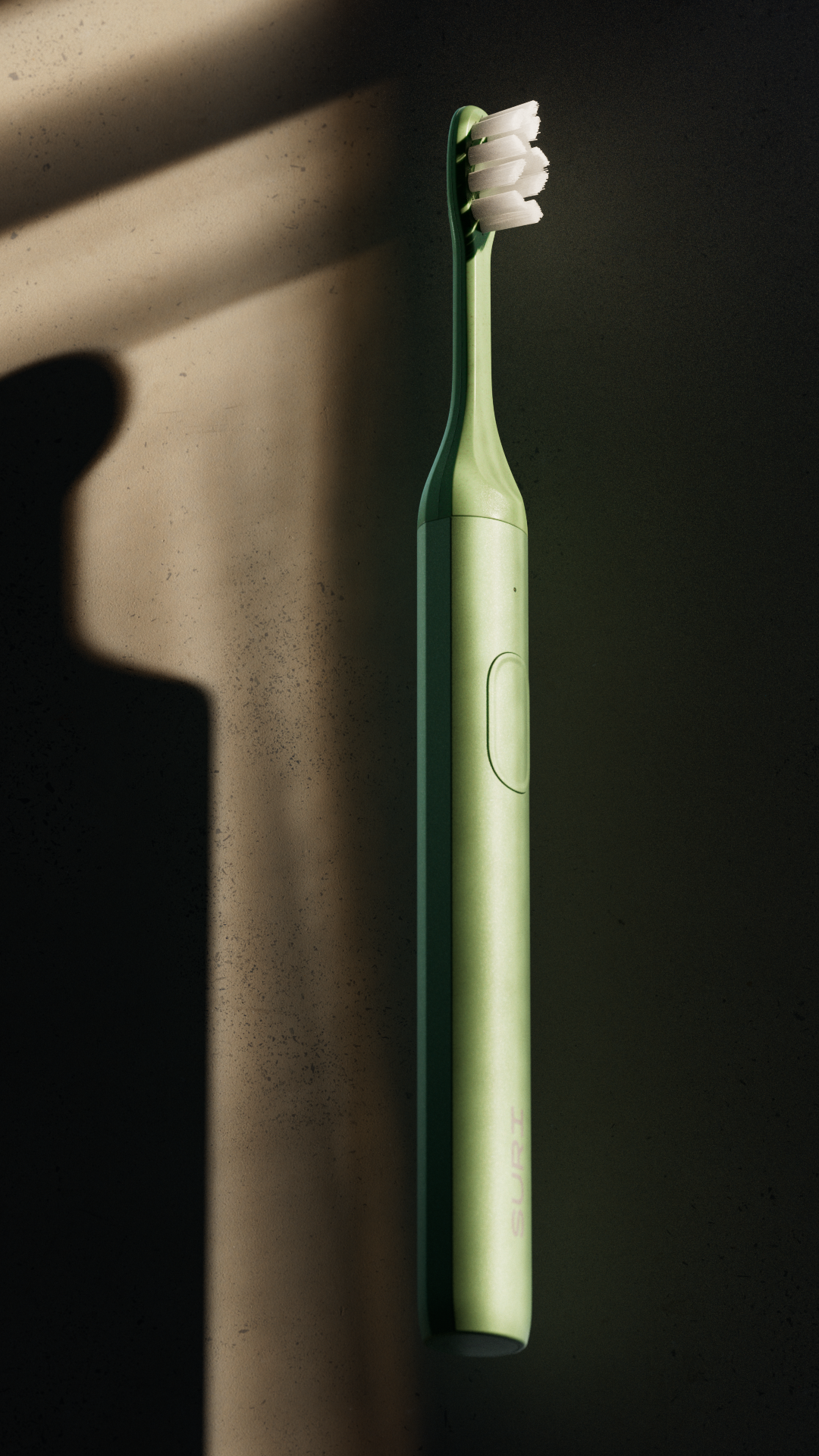 A sleek, green electric toothbrush with a minimalist design, standing upright against a dark background with a soft shadow cast by its handle.