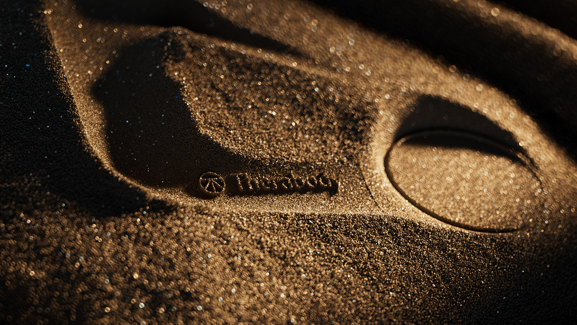 A close-up of a Therabody device with sand adhering to its surface, showing the brand's texture and craftsmanship.