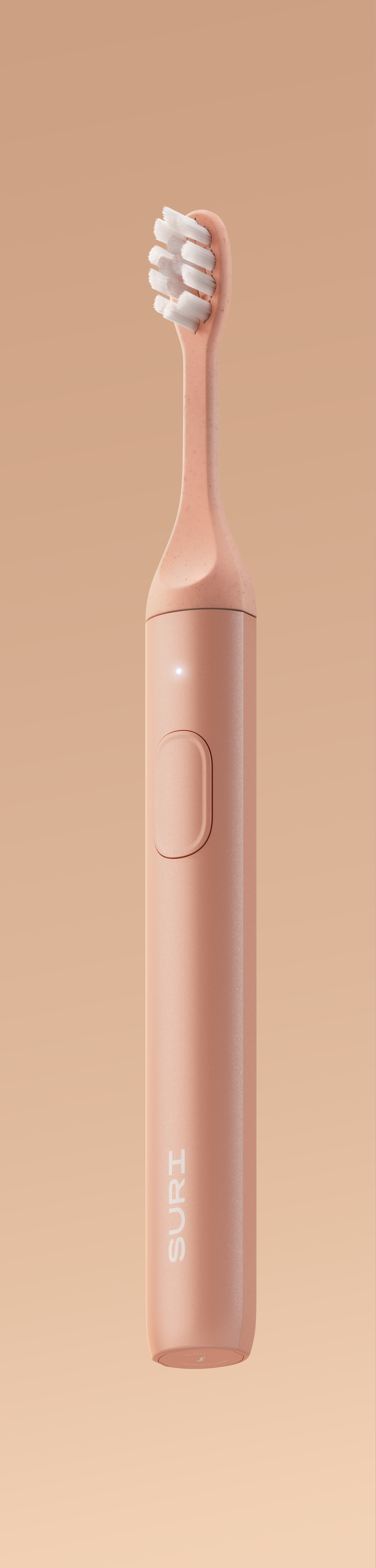 A sleek, peach-colored electric toothbrush with a minimalist design, featuring a button on the side and the brand name "SURI" on the handle.