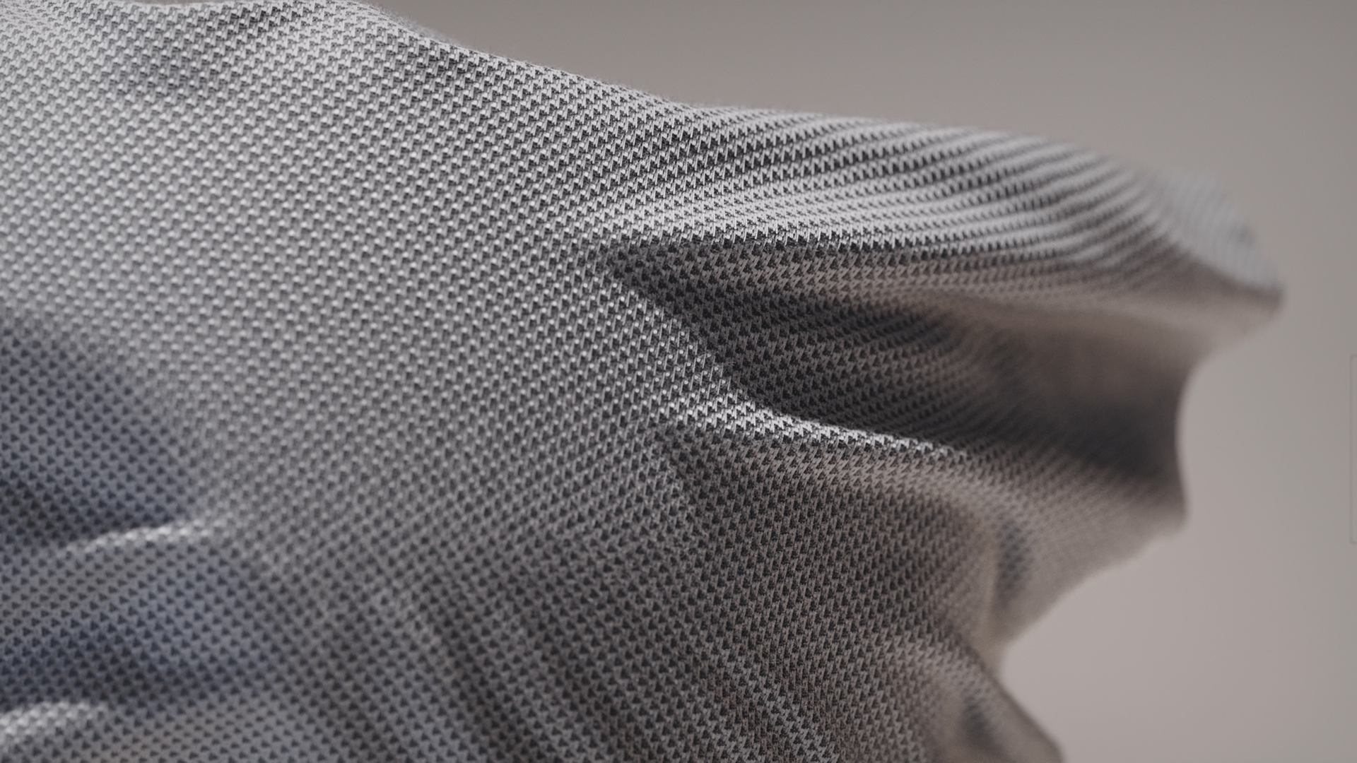 A close-up of a textured, gray fabric with a subtle pattern.
