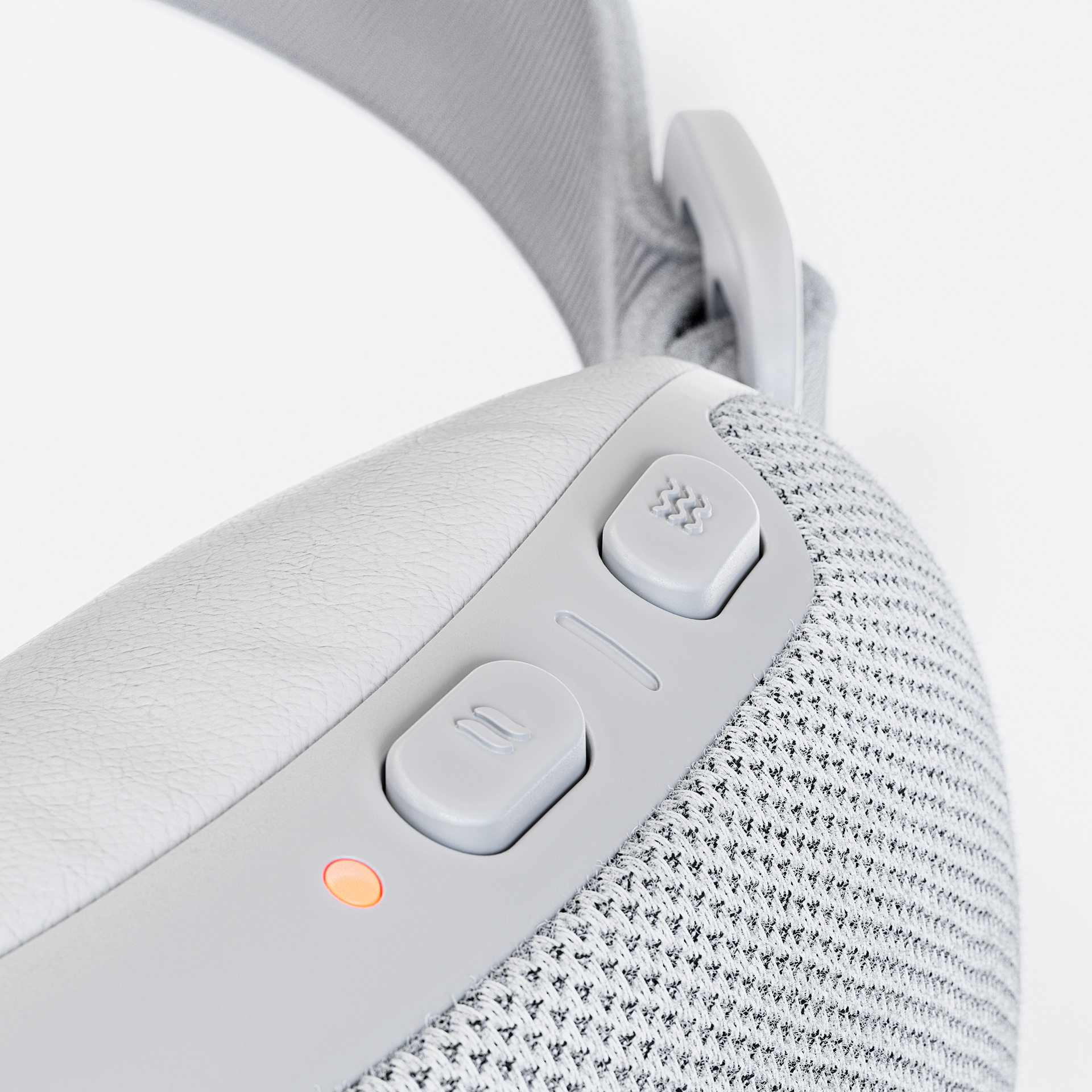Close-up of a white VR headset with control buttons and a red light indicator.