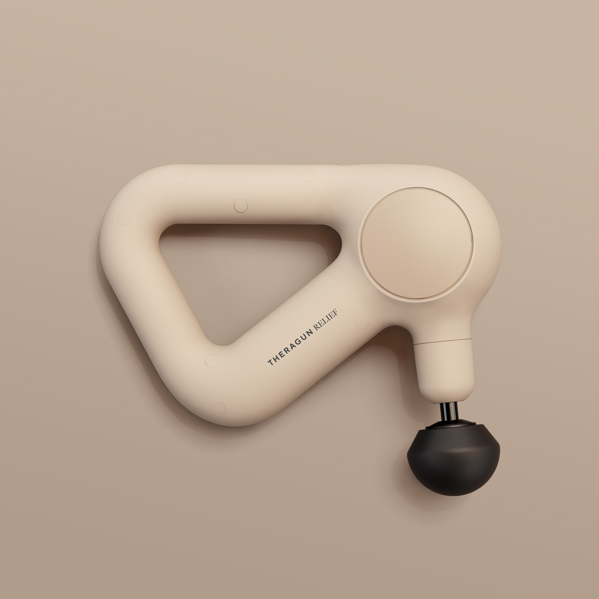 A beige Theragun Pro Plus device with a black massage ball attachment on a neutral background.