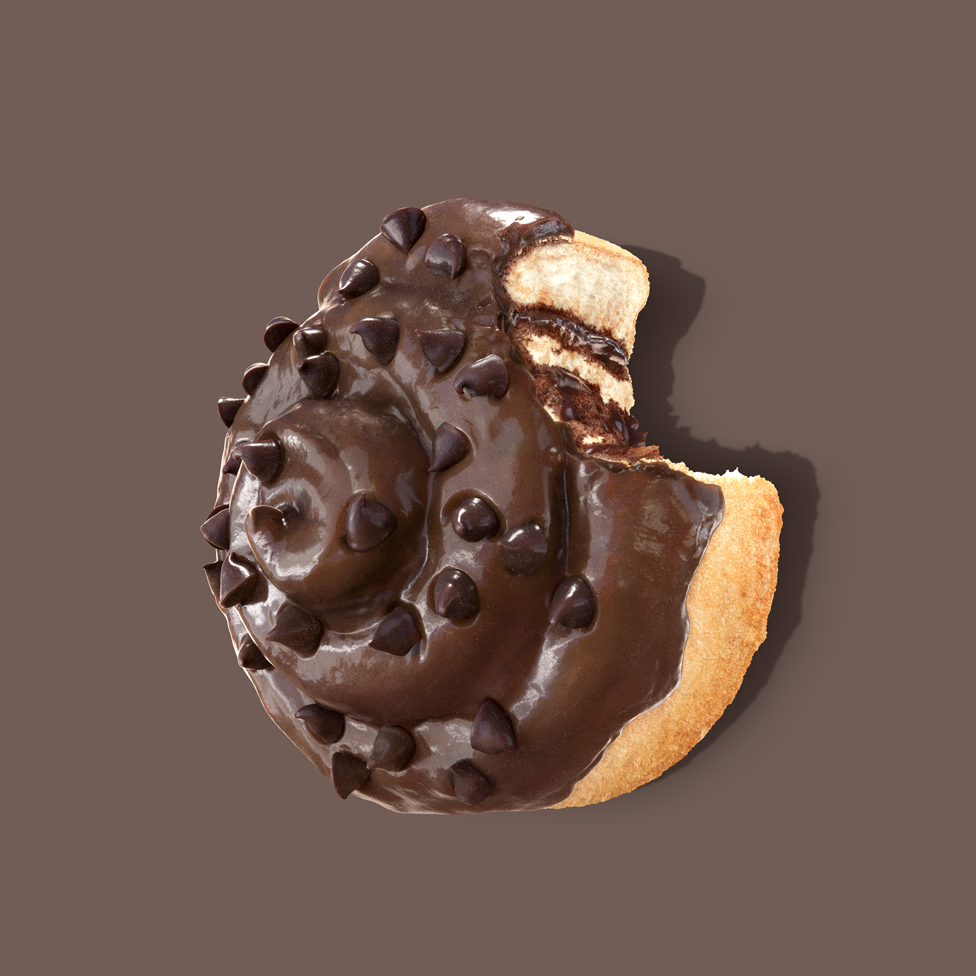 A chocolate-covered doughnut with chocolate chips, partially eaten, against a dark background.