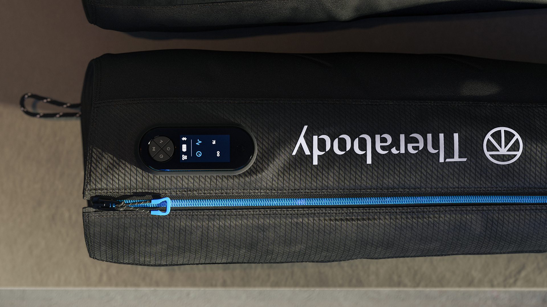 A black Therabody recovery air jetboot with a blue zipper and a digital control panel displaying various settings.