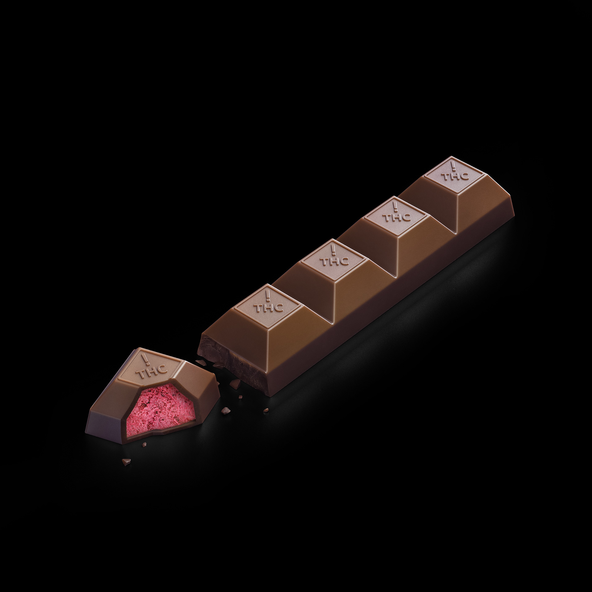 A luxury chocolate bar with a pink filling, partially bitten, showing the brand name "TAC" on each piece.
