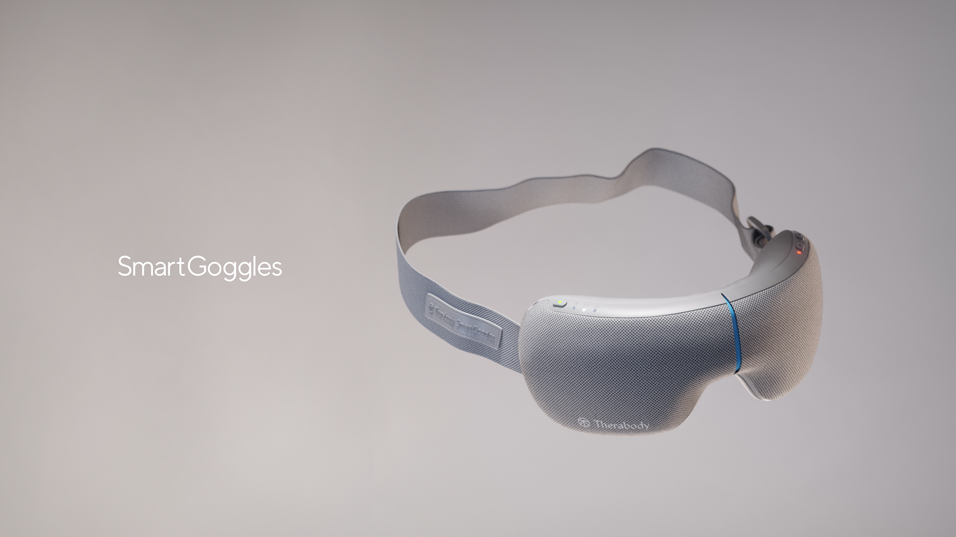 A sleek, gray smartgoggles device with a blue light and red indicator, designed by Therabody.