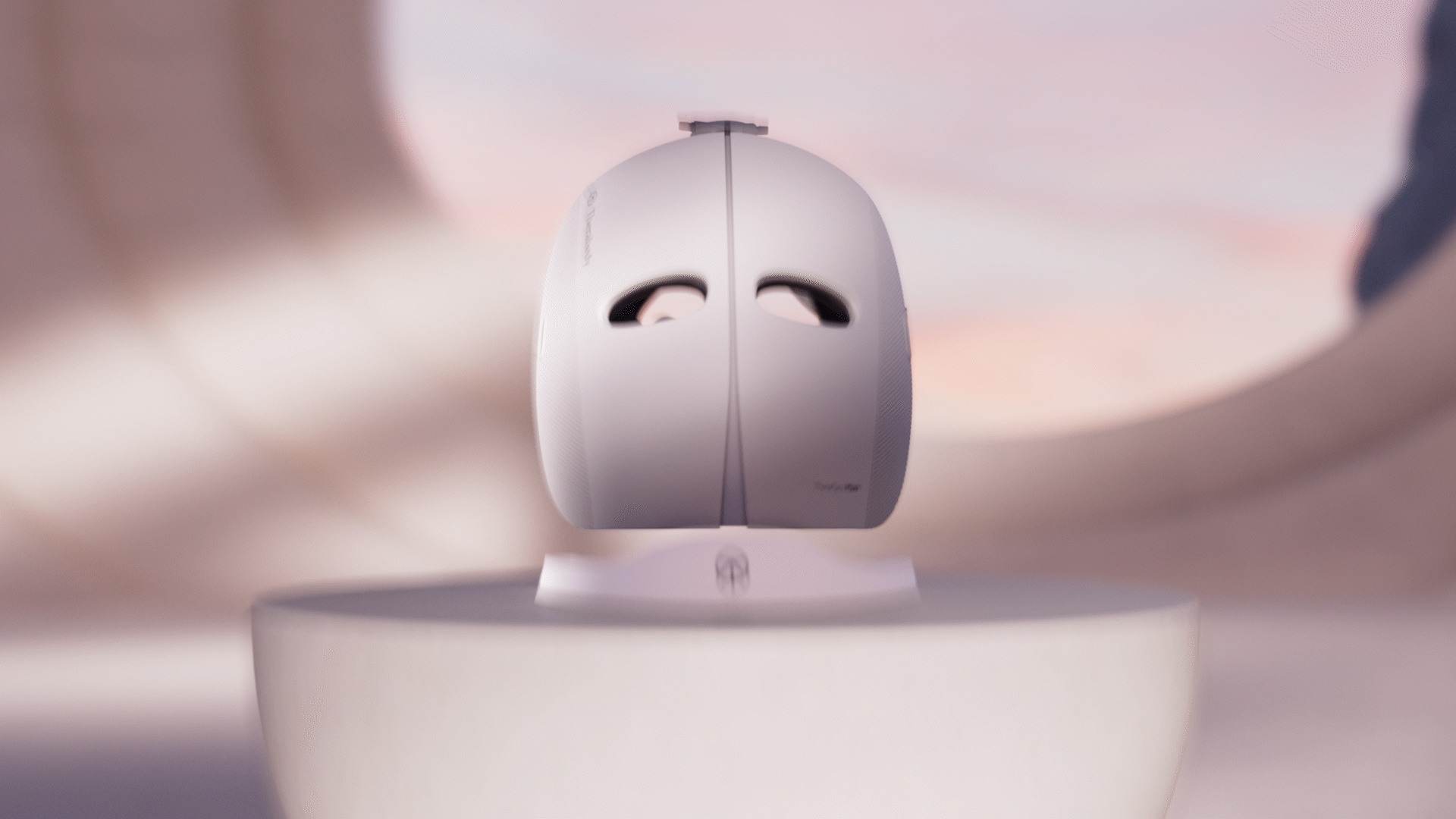 Animated sequence: A sleek, futuristic mask with "Therabody" branding on its side, floating against a gradient background.