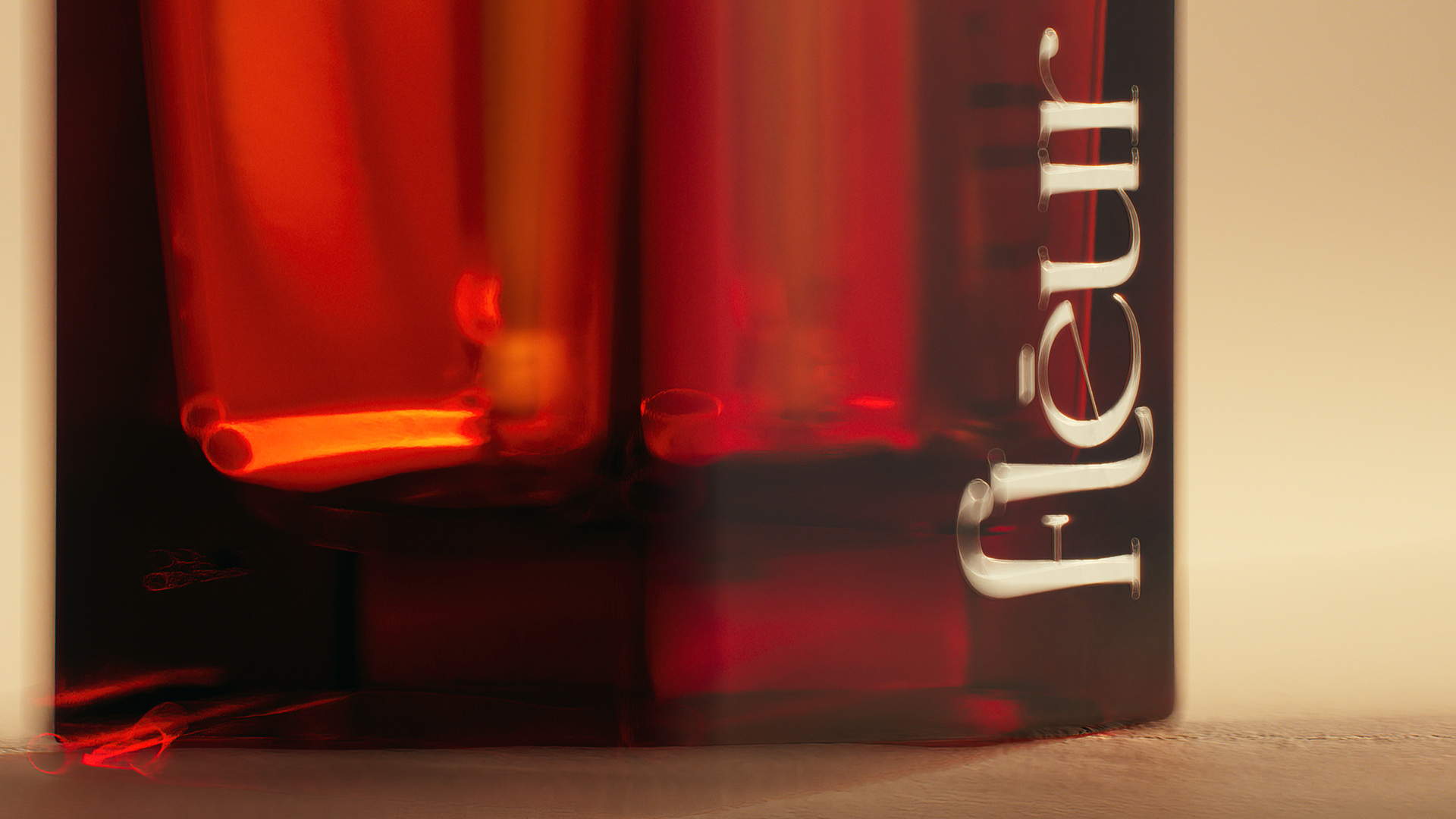 Close-up of red glass tubes filled with liquid, labeled "fleur" on a dark background.