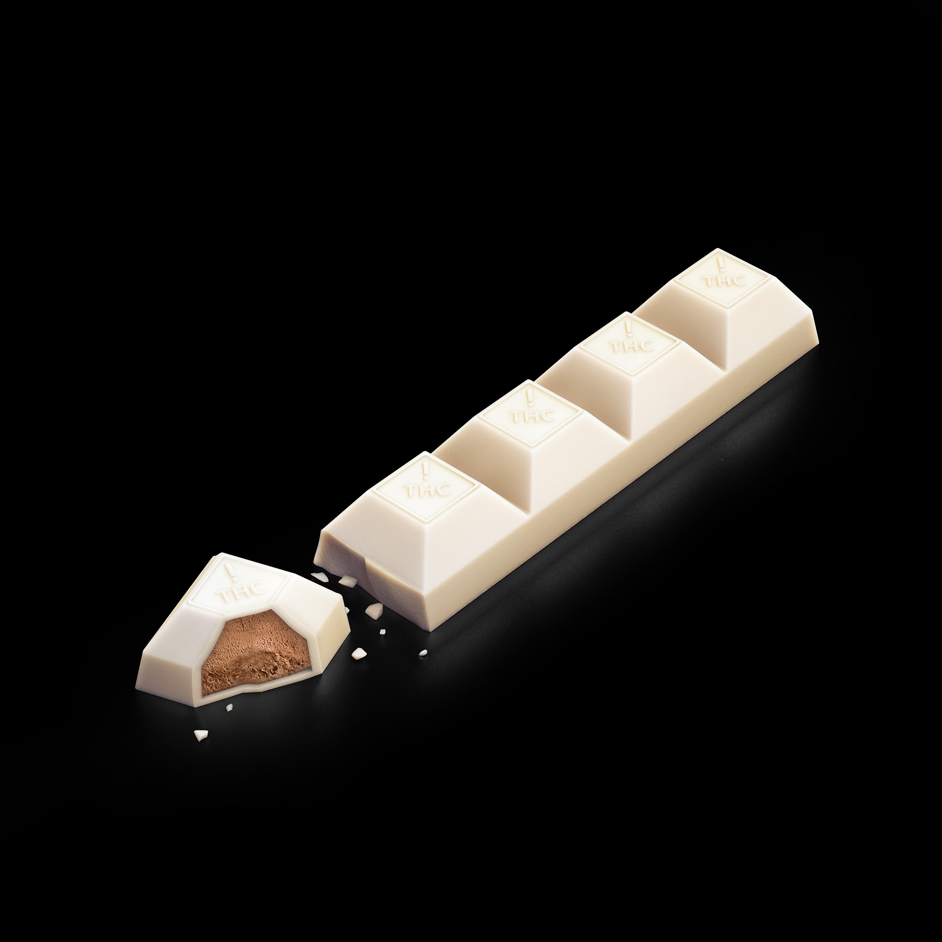 A white chocolate bar with a single piece missing, revealing a dark chocolate center.