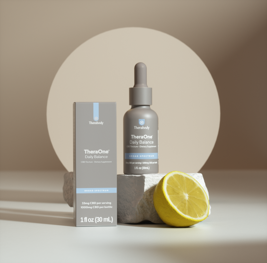 TheraOne Daily Balance CBD serum bottle next to lemon slice and box on white surface. 30mg CBD per serving. 1 fl oz (30 mL).