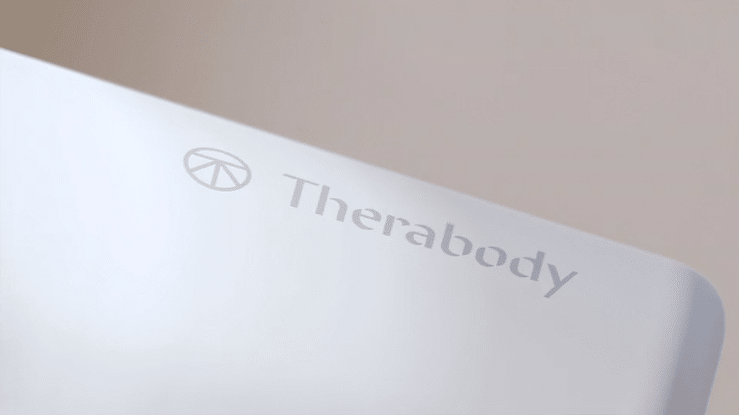 Animated sequence: A close-up of a white device with a blue light on its side, featuring the text "The pioneers of percussive therapy" and a logo resembling a hand with raised fingers.