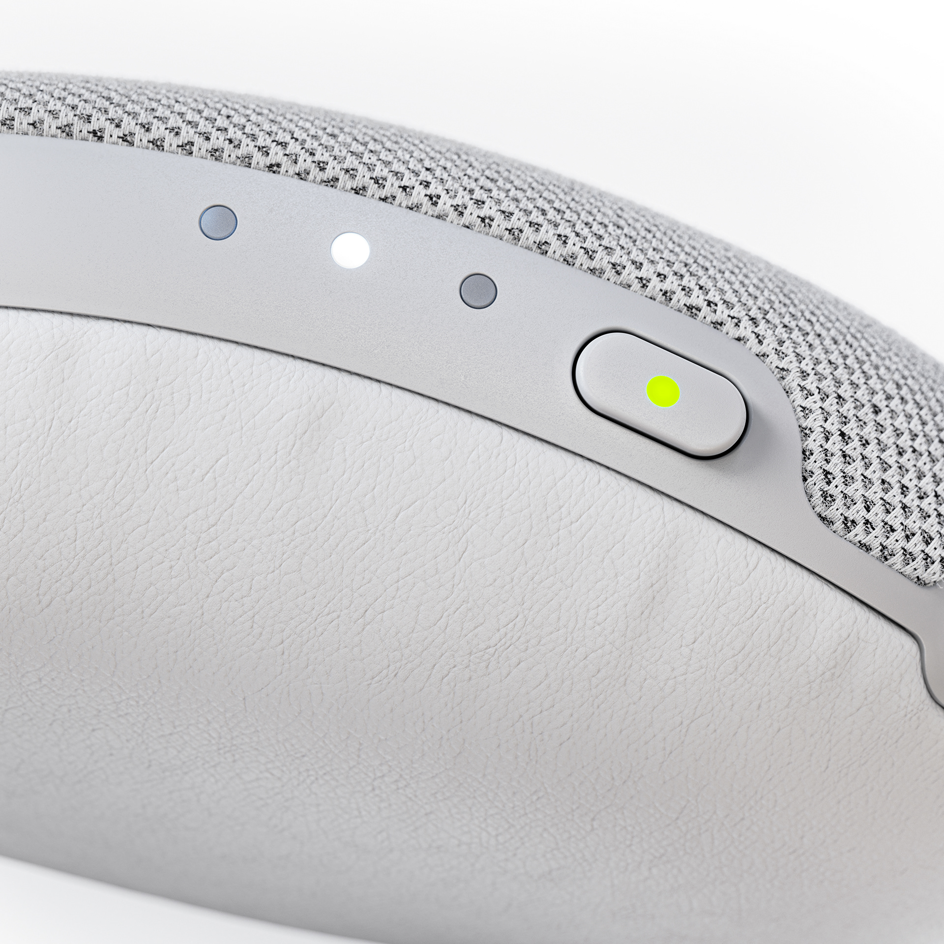 A close-up of a white, textured device with a power button illuminated green.