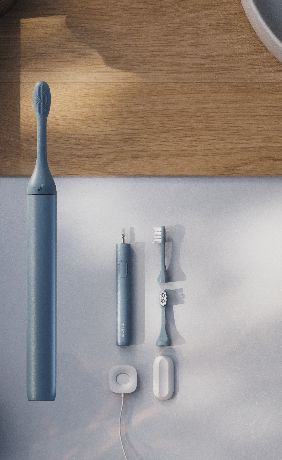 A electric toothbrush package featuring a blue toothbrush, travel case, and charging dock on a wooden surface.