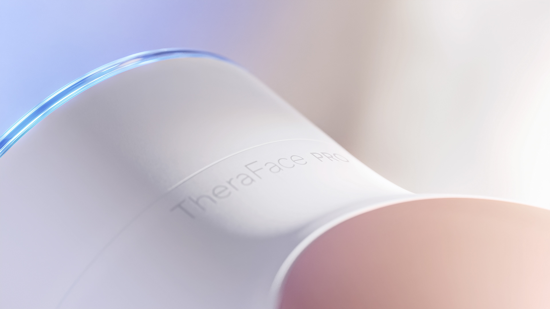 A sleek, white device with a blue light on top, labeled "TheraFacs Pro," against a blurred background.
