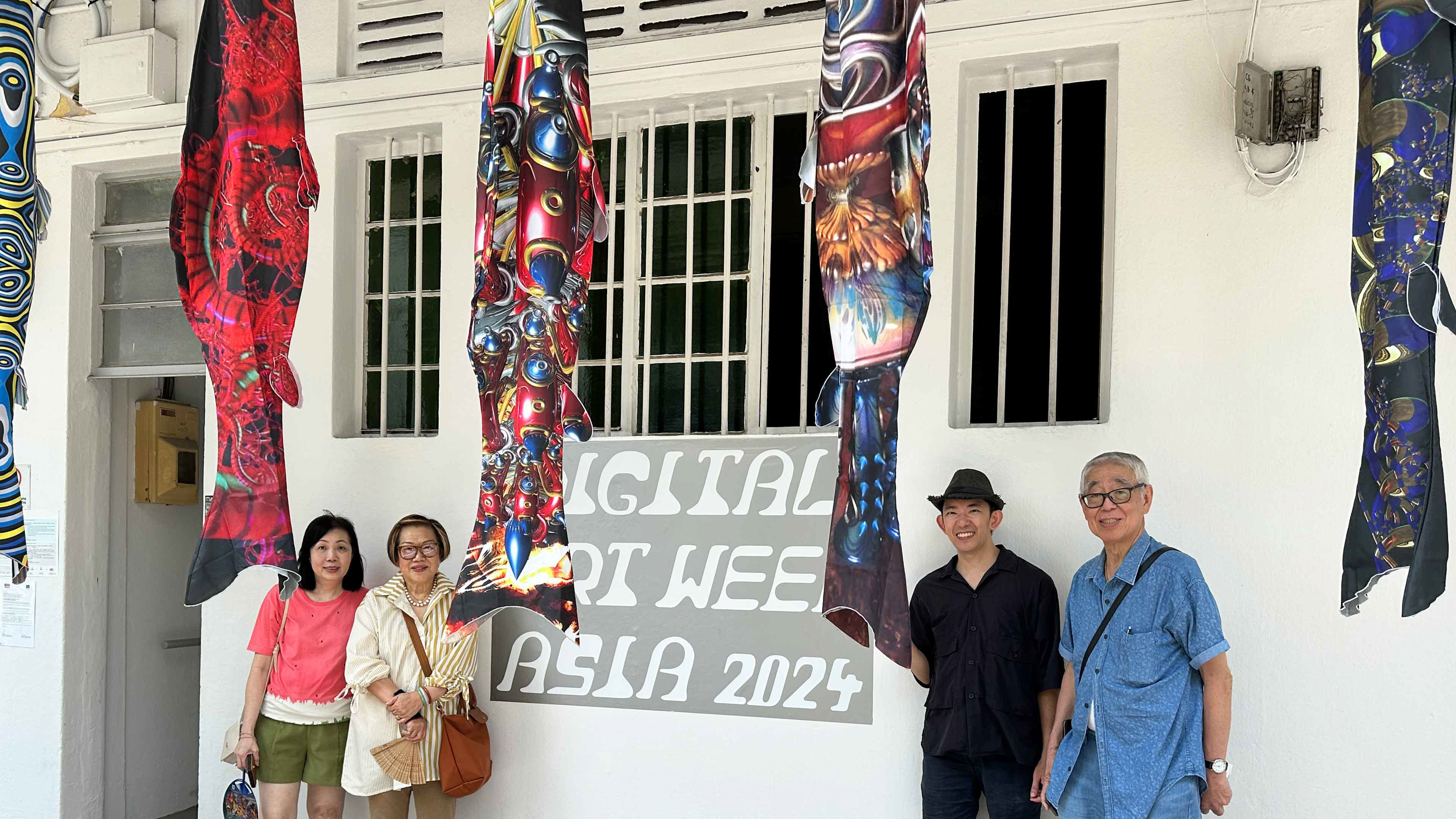 Television legend Robert Chua and family with Curator Warren Wee pose outside the facade of the historic Tiong Bahru venue