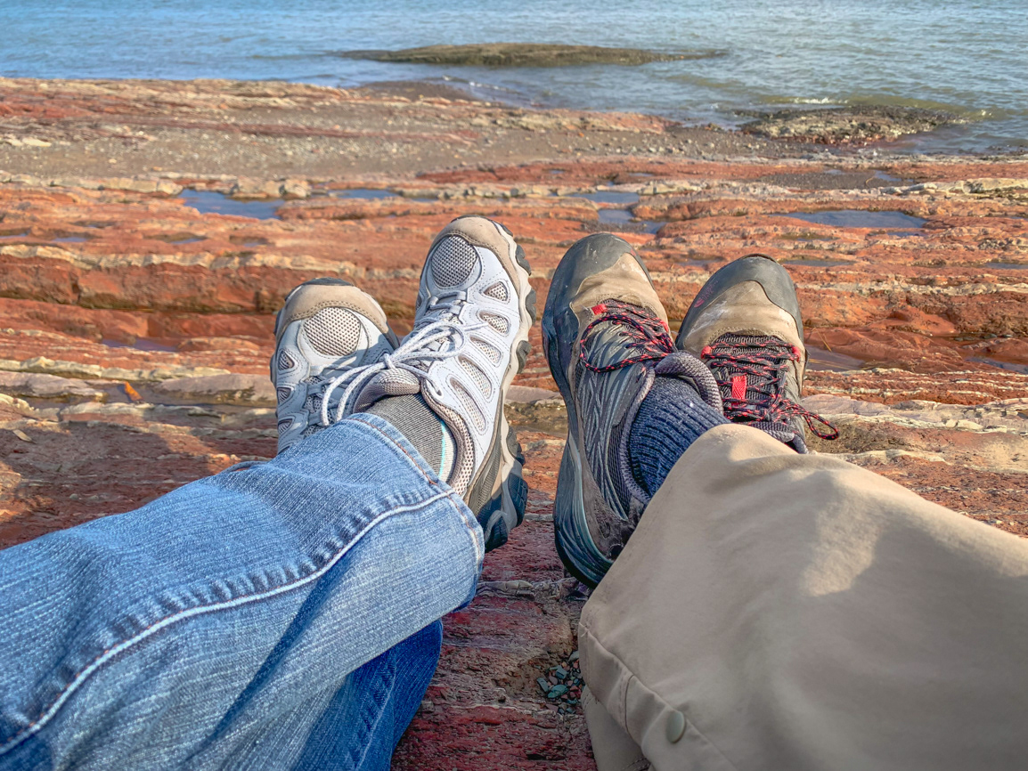 Taking a break on the sedimentary rock just off the parking lot of Église Saint-Jean de l'île d'Orléans - Île d'Orléans, Quebec CA