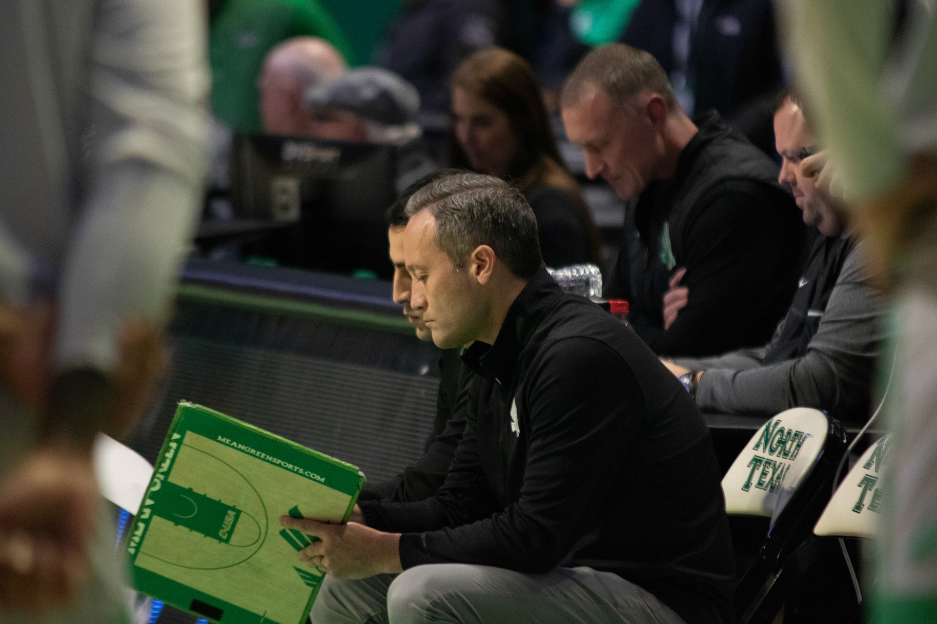 Coach McCasland sits on the side lines looking at his clipboard at the Super Pit on January 20, 2022 in Denton, Texas.
