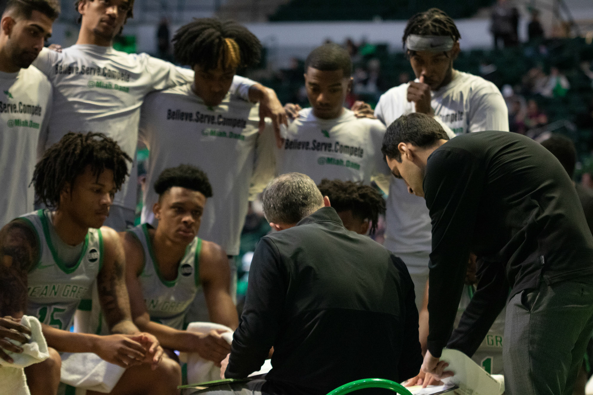 The Mean Green Men’s basketball team listens to Coach McCasland as he talks to them during a timeout at the Super Pit on January 20, 2022 in Denton, Texas.
