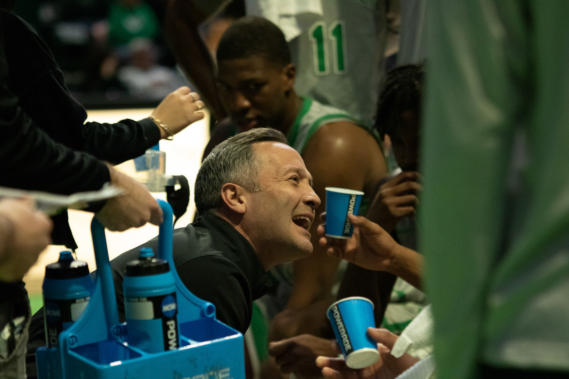 Coach McCasland speaks with the team during a timeout as they hydrate at the Super Pit on January 20, 2022 in Denton, Texas.